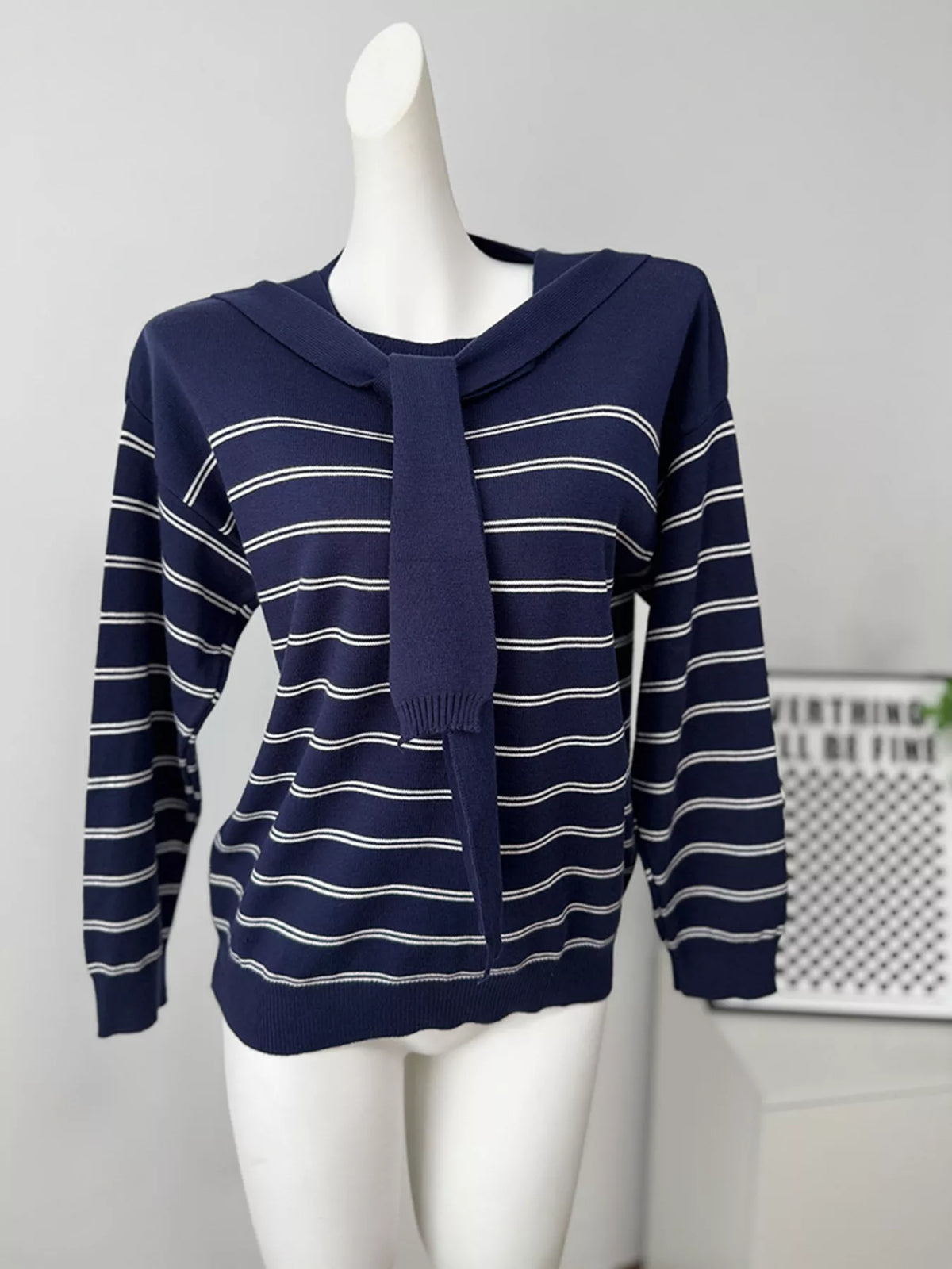 Striped crewneck sweater with layered tie detail in navy, front mannequin view with tie
