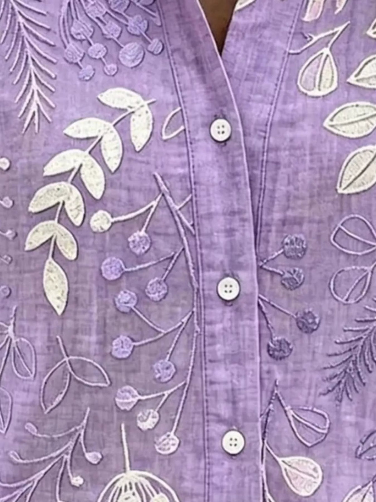 Purple leaf-embroidered button-down shirt, leaf embroidery and button detail.