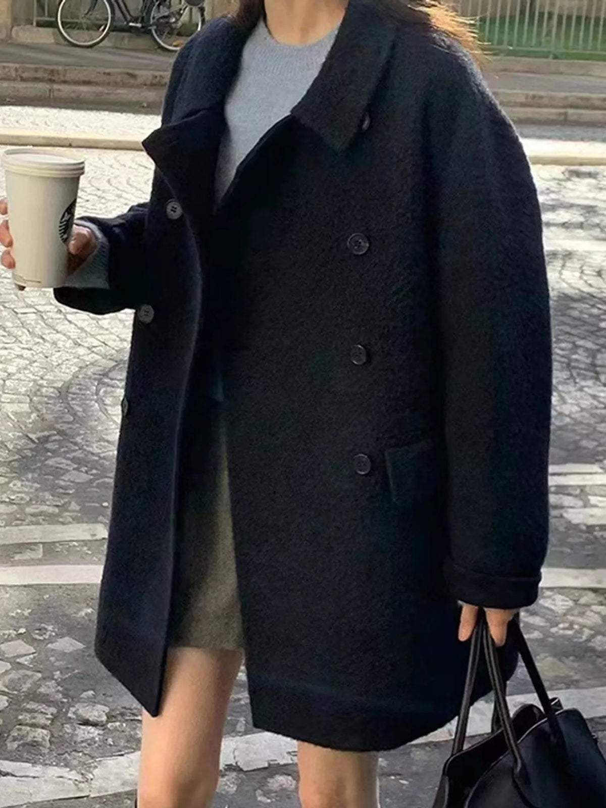 Black double-breasted wool-blend coat — front view