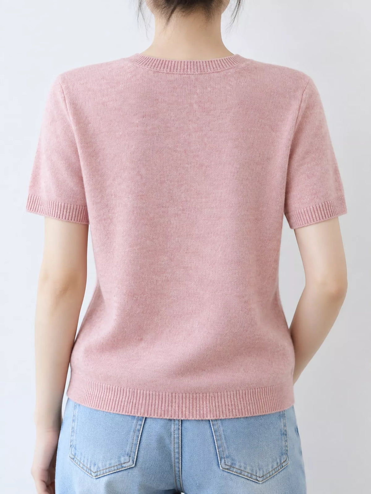 Pale pink round neck short-sleeve sweater, back view