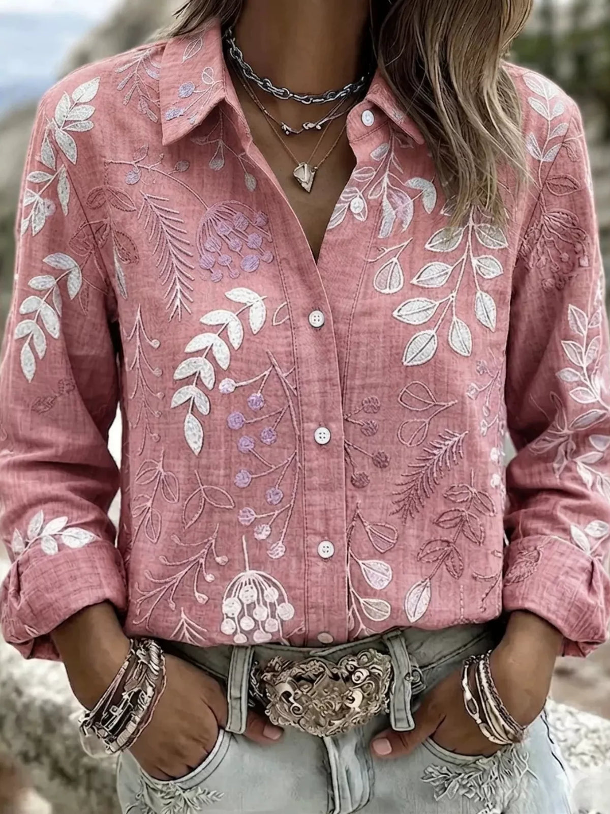Pink leaf-embroidered button-down shirt, front view.
