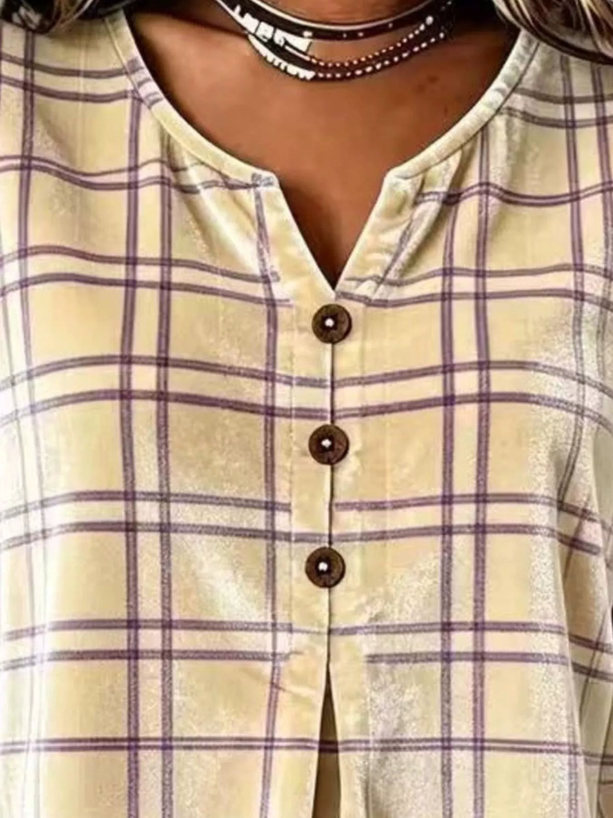 Yellow plaid velvet balloon-sleeve blouse, neckline and buttons close-up