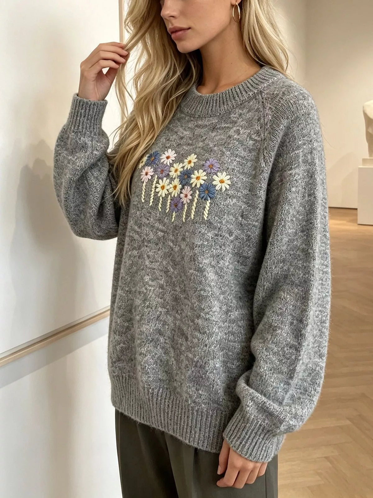Floral embroidered round-neck sweater in gray, raised-arm view