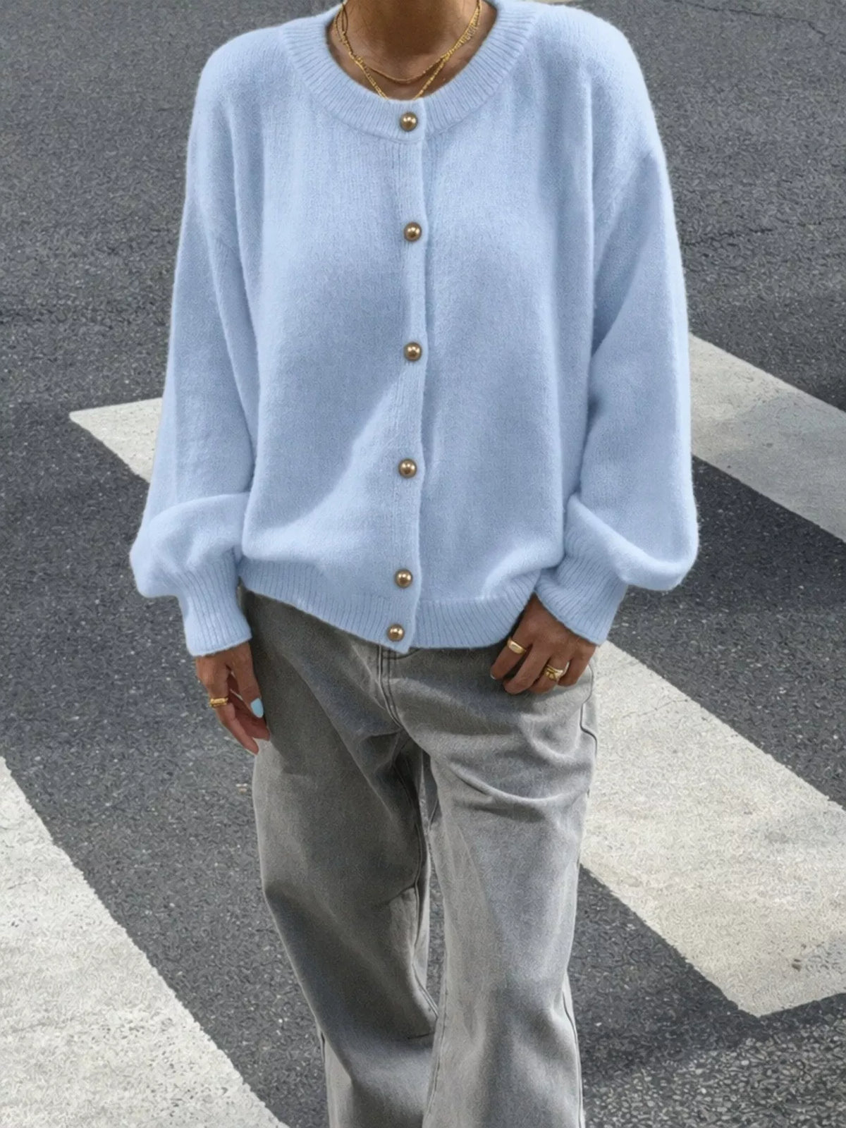 Light blue round-neck button-front knit cardigan, front view from above.