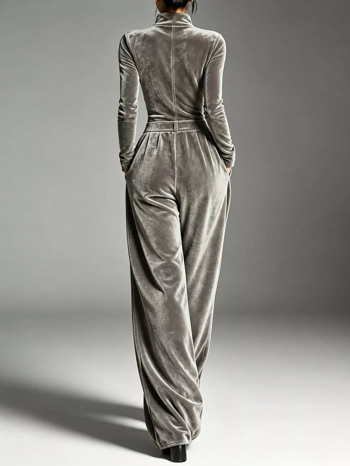 Gray velvet zip up jumpsuit with tie waist, back view