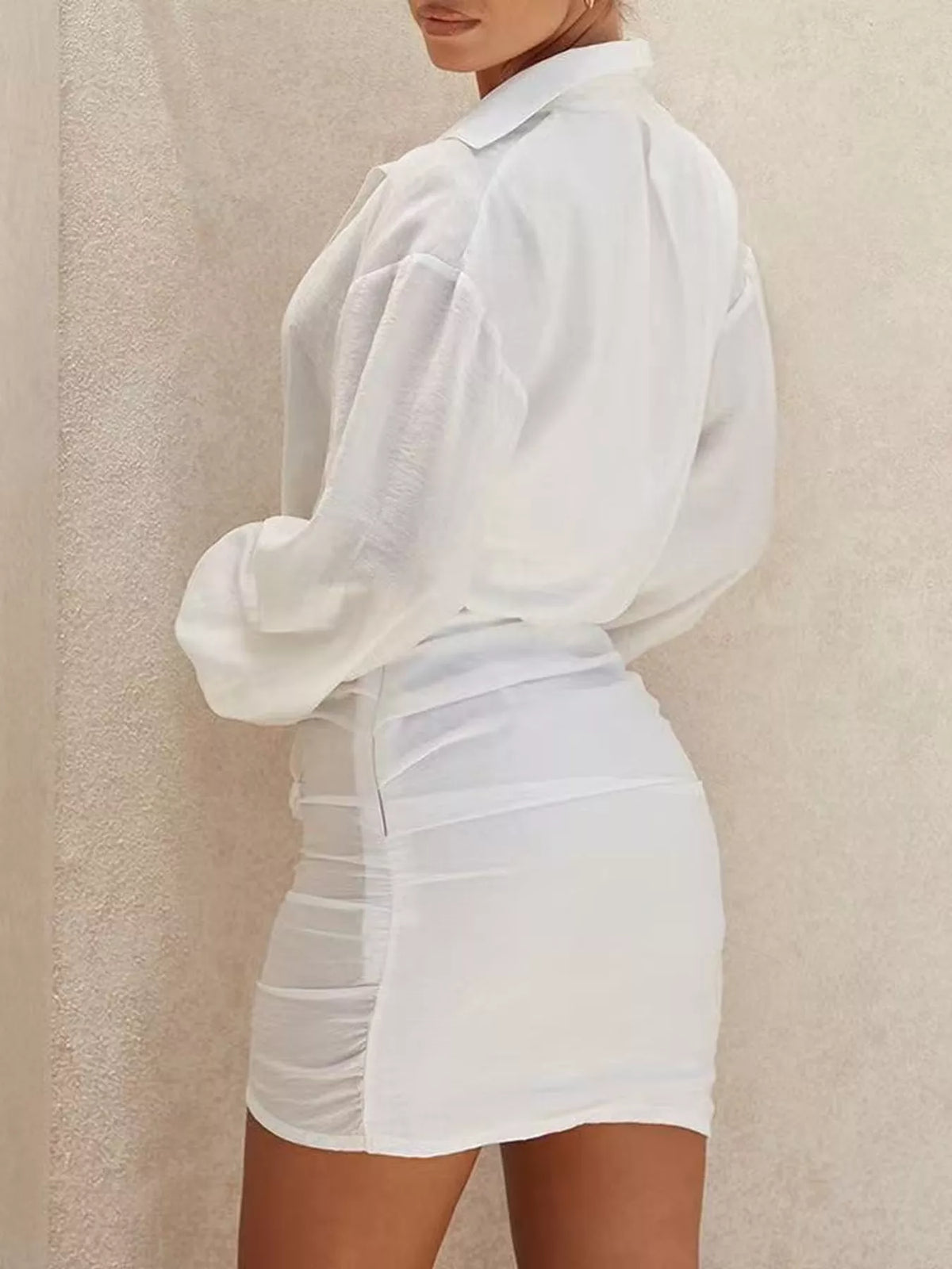 White deep v-neck ruched asymmetric mini dress, back view.