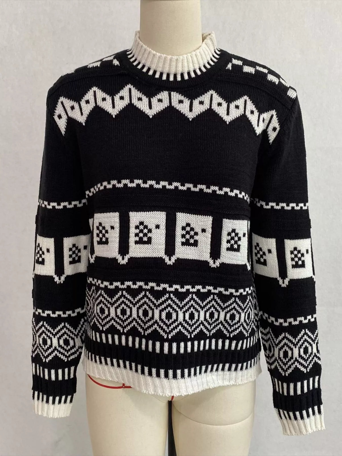 Black and white christmas fair isle crewneck sweater, front on dress form.