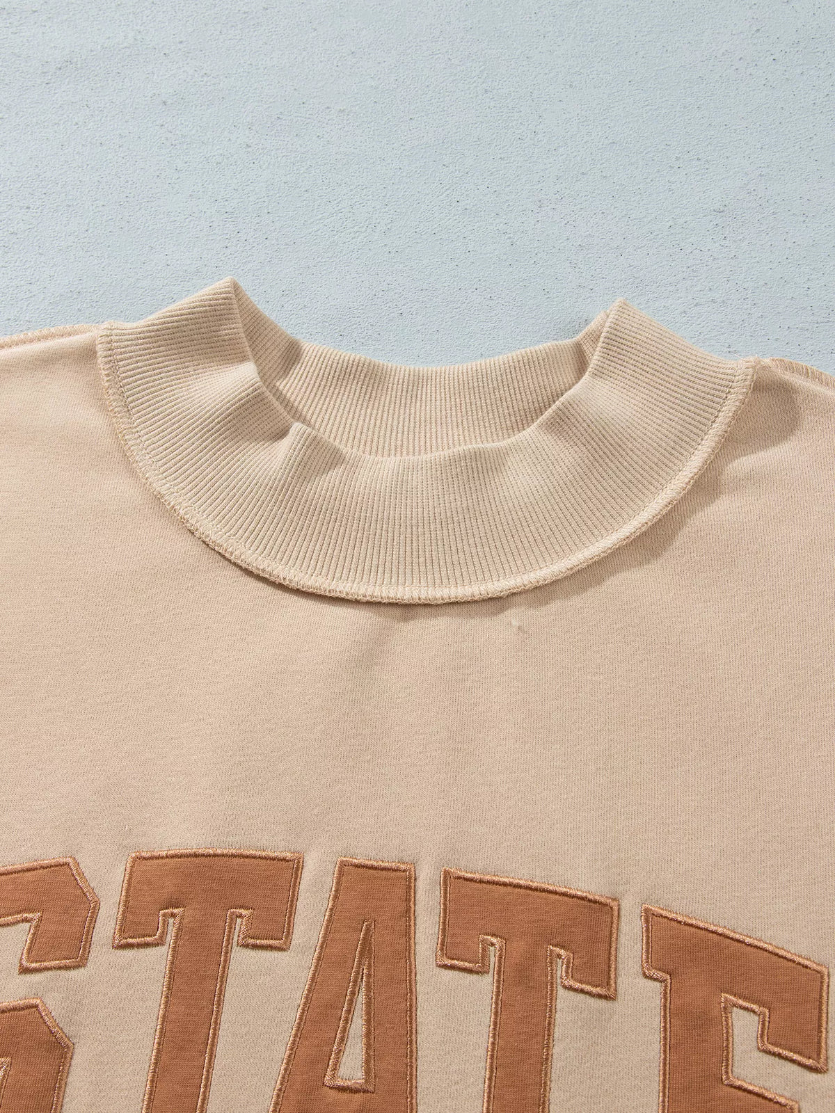 STATE Graphic Exposed Seam Mock Neck Sweatshirt — construction details