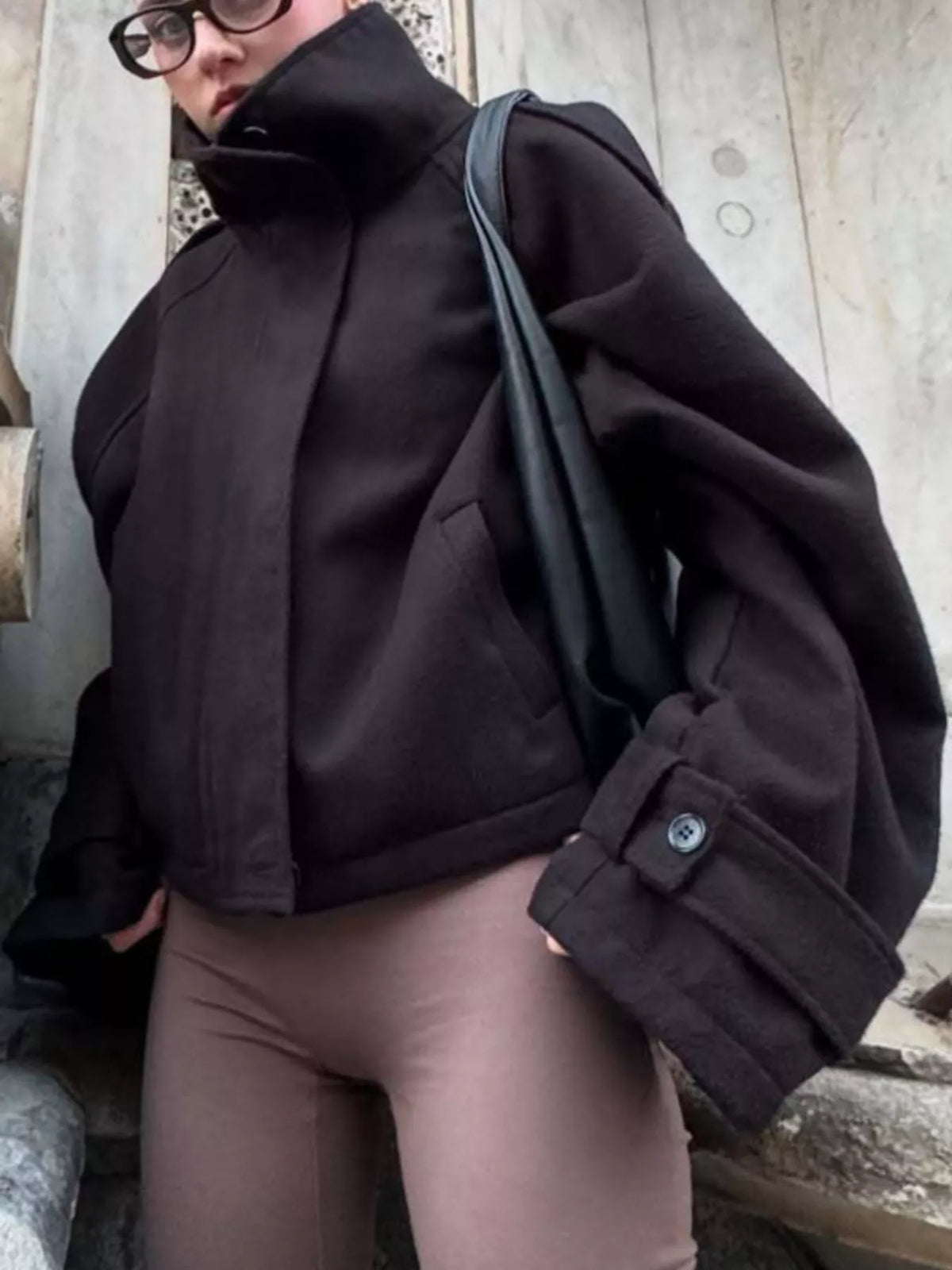 Black zip-up stand-collar jacket — front view
