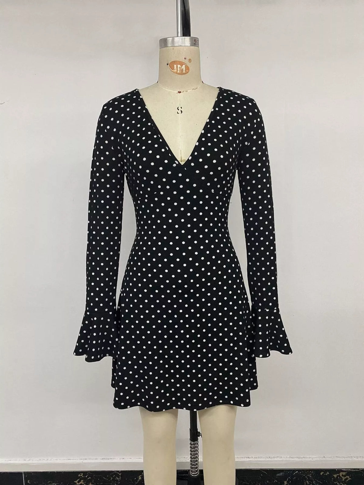 Black polka dot flounce sleeve mini dress, front on mannequin