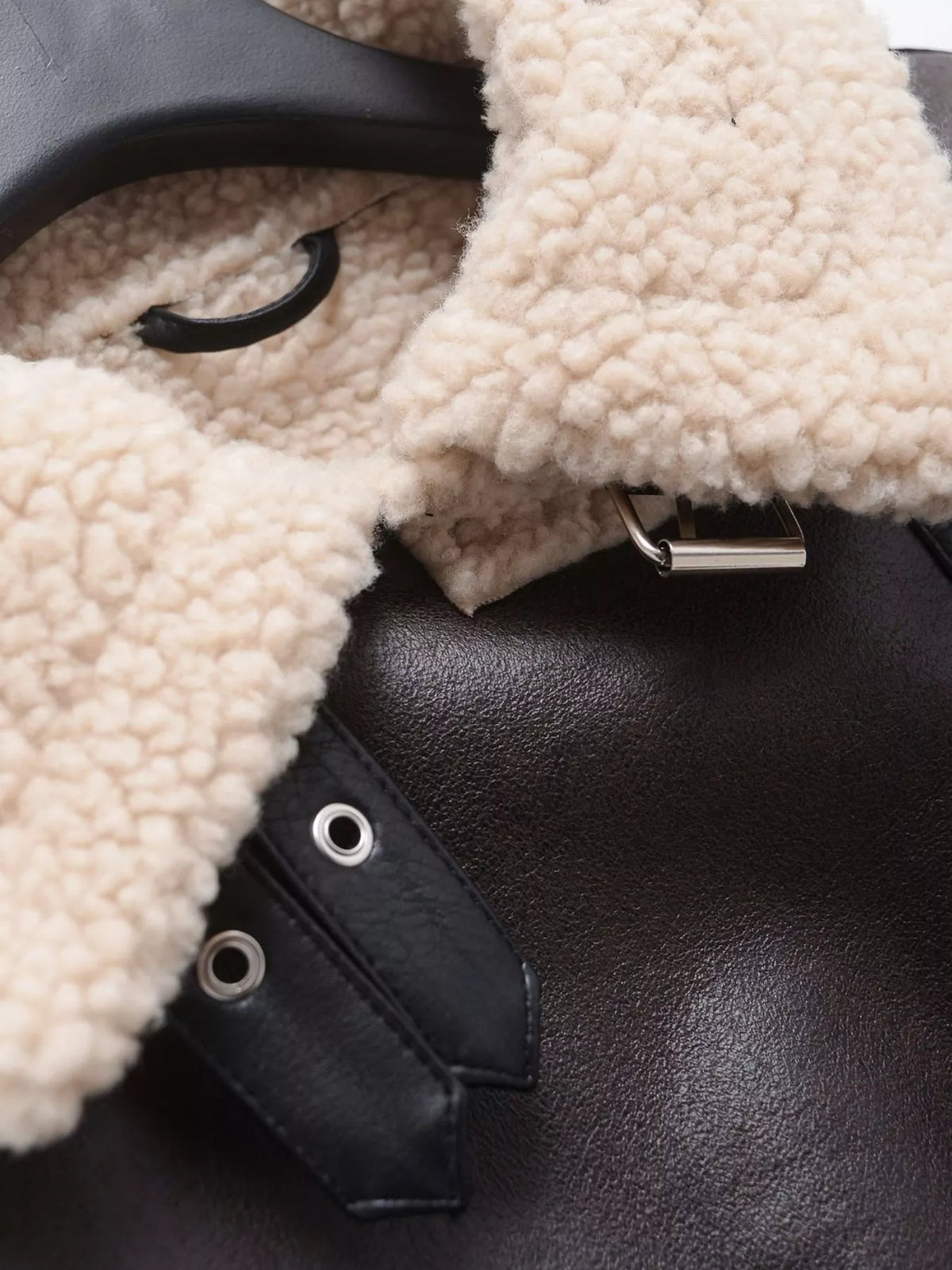 Black with cream trim faux leather zip up jacket, detail view