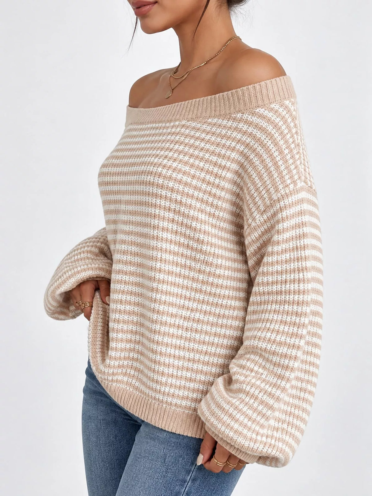 Beige and white striped knit boat neck sweater, side view