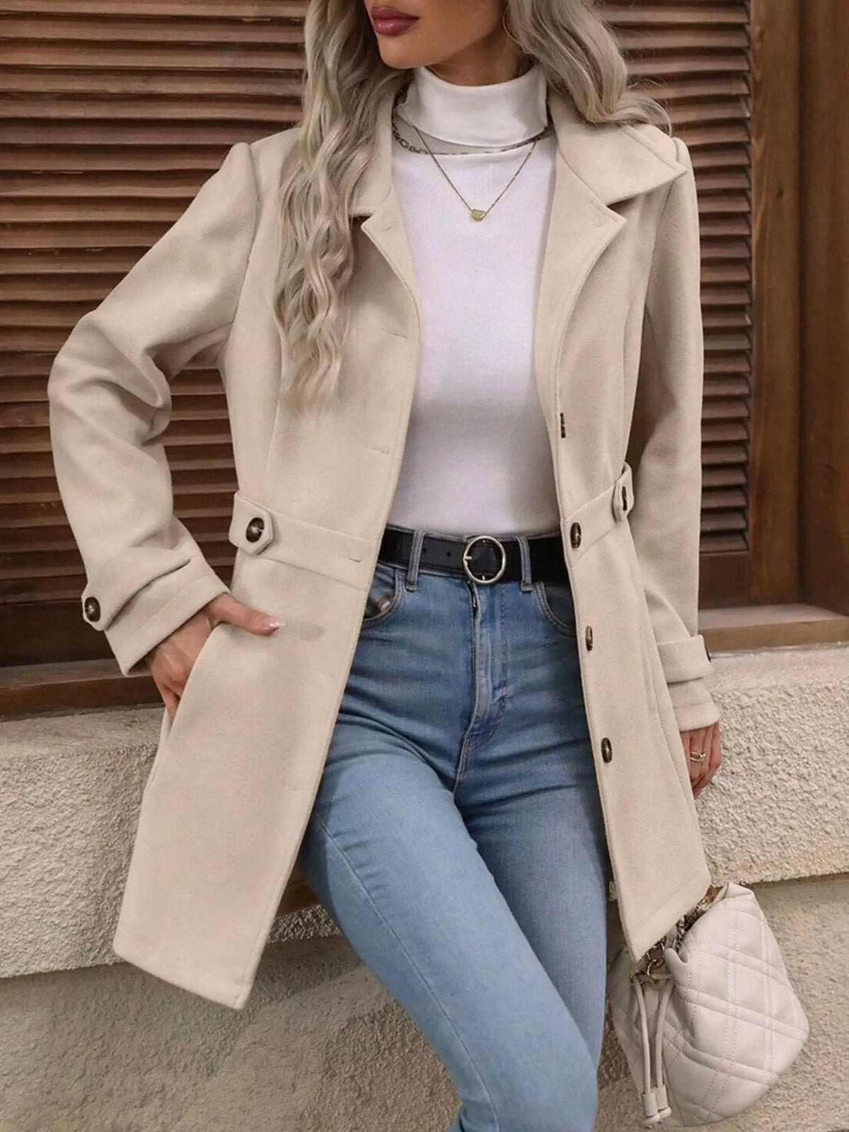 Beige single-breasted coat, open front view with hand at hip
