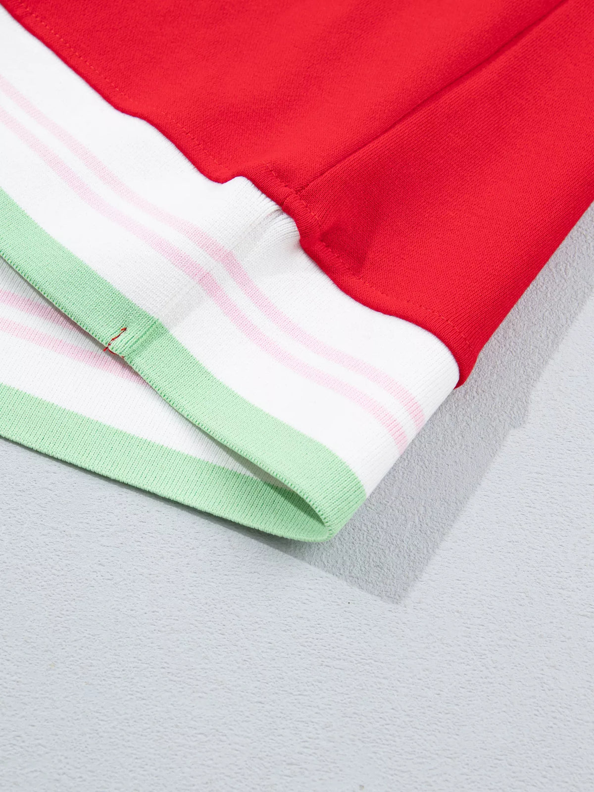 Red sweatshirt with contrast striped ribbed trim, hem detail