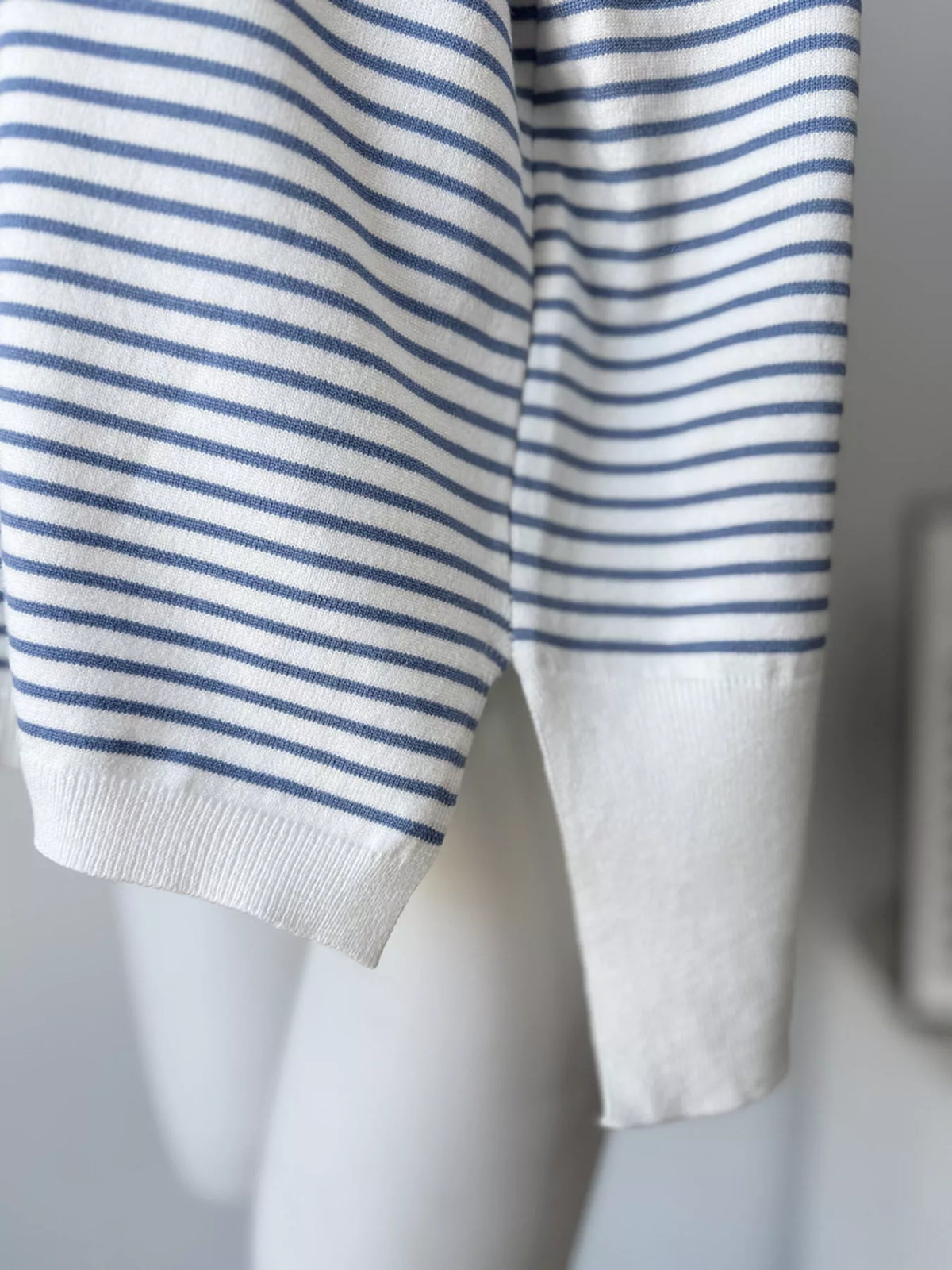 Striped round-neck knit top in white and blue, side slit detail