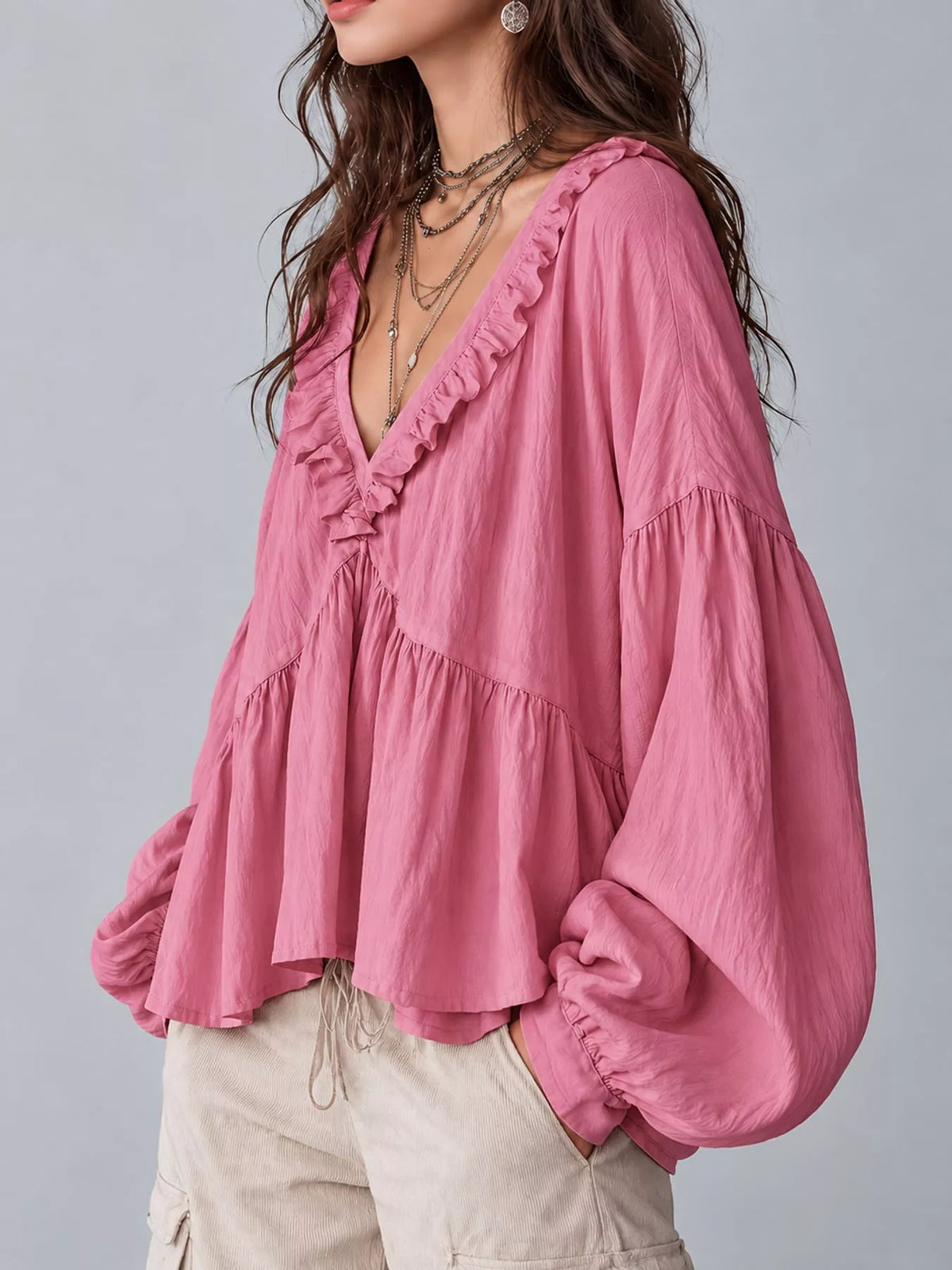 Pink ruffled v neck blouse, side view