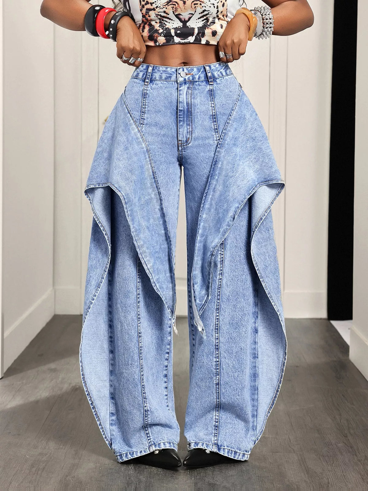 Light blue ruffled wide-leg jeans, front view with hands at waist
