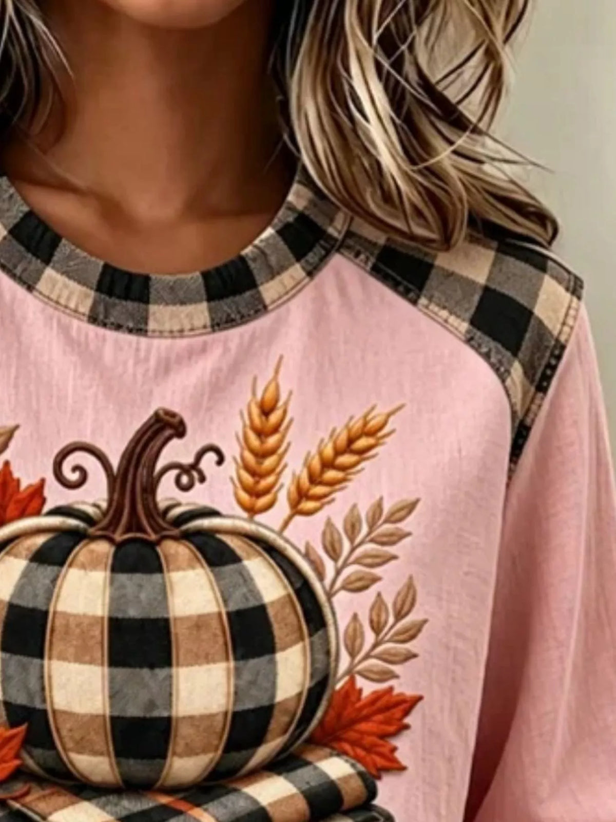 Pink pumpkin-patchwork sweatshirt, neckline and graphic detail