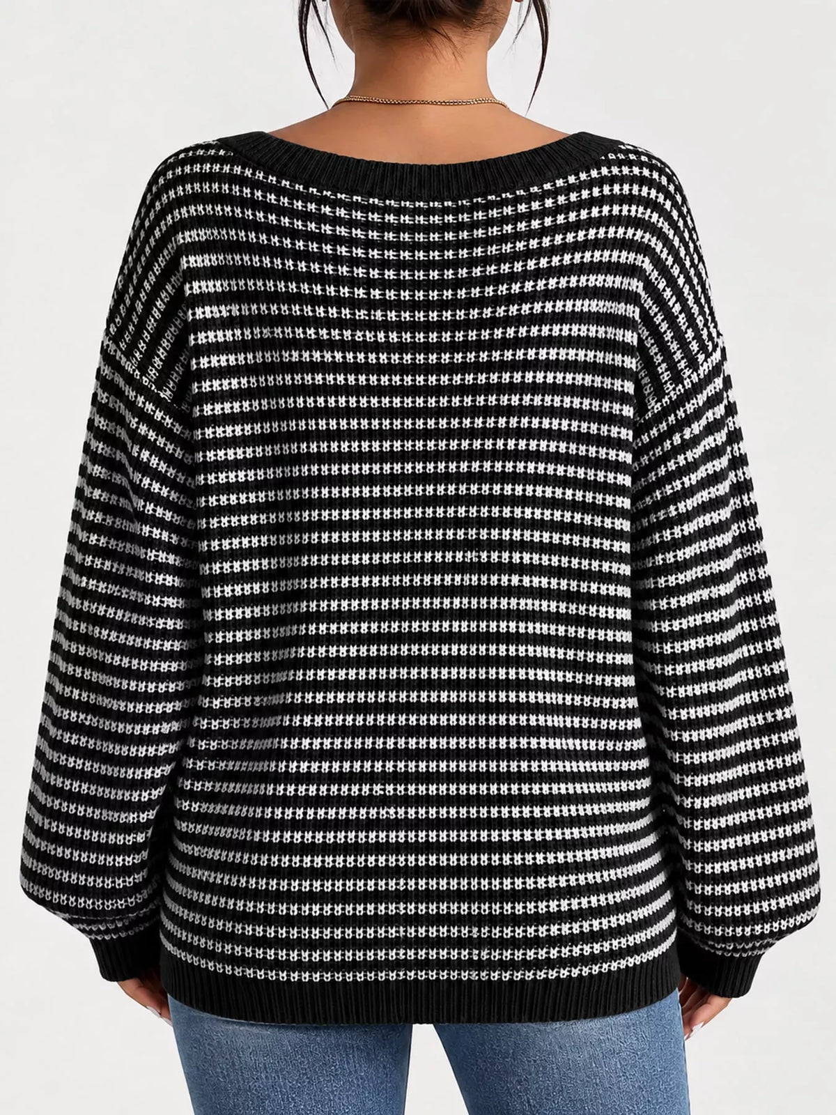 Black and white striped knit boat neck sweater, back view