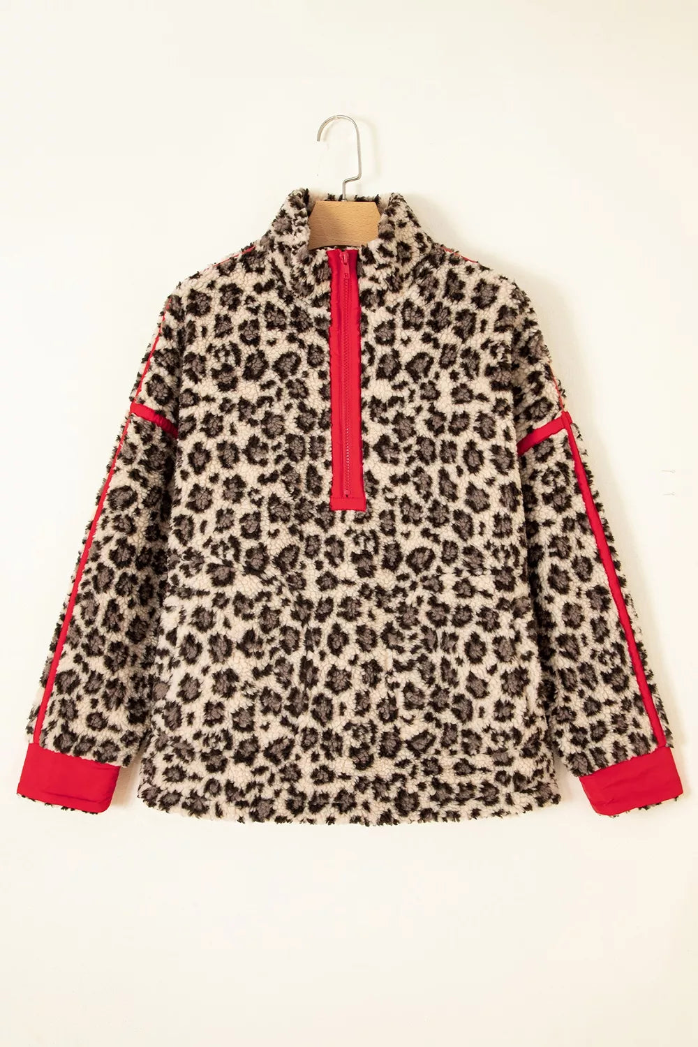 Leopard leopard half-zip sweatshirt with red trim, front on hanger.