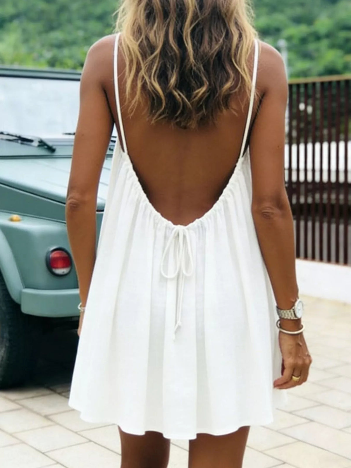 White spaghetti strap A-line mini dress with open tie back, open back view
