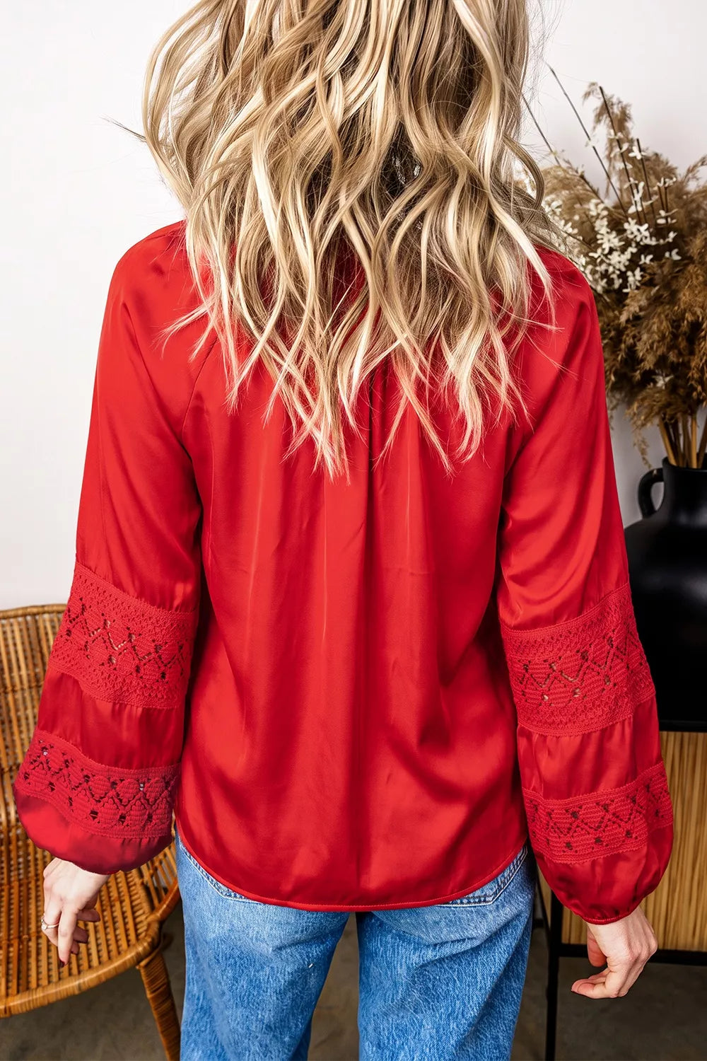 Red lace-panel v-neck button-front shirt, back view.