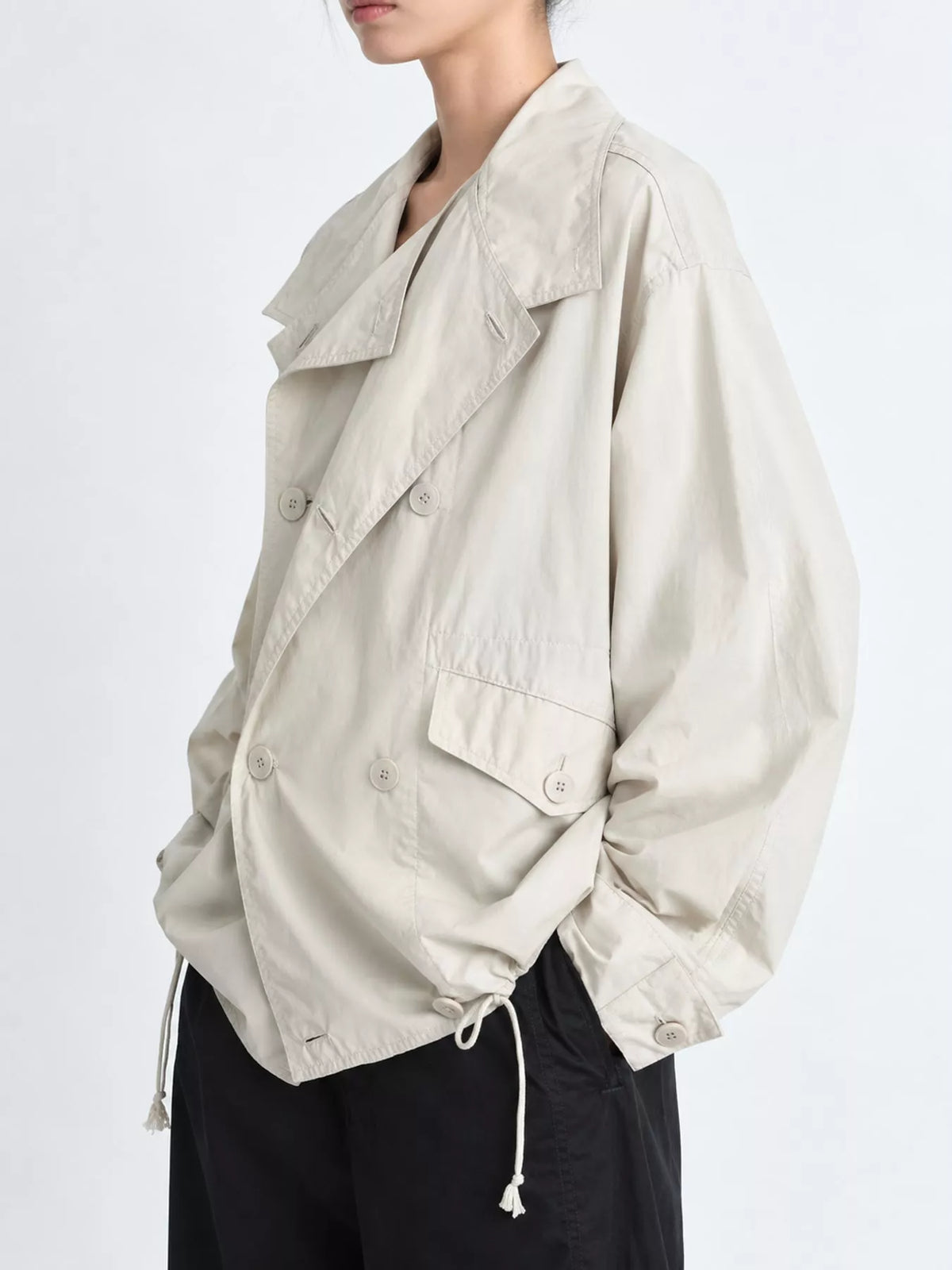 Cream double-breasted utility jacket with drawstring hem — side view