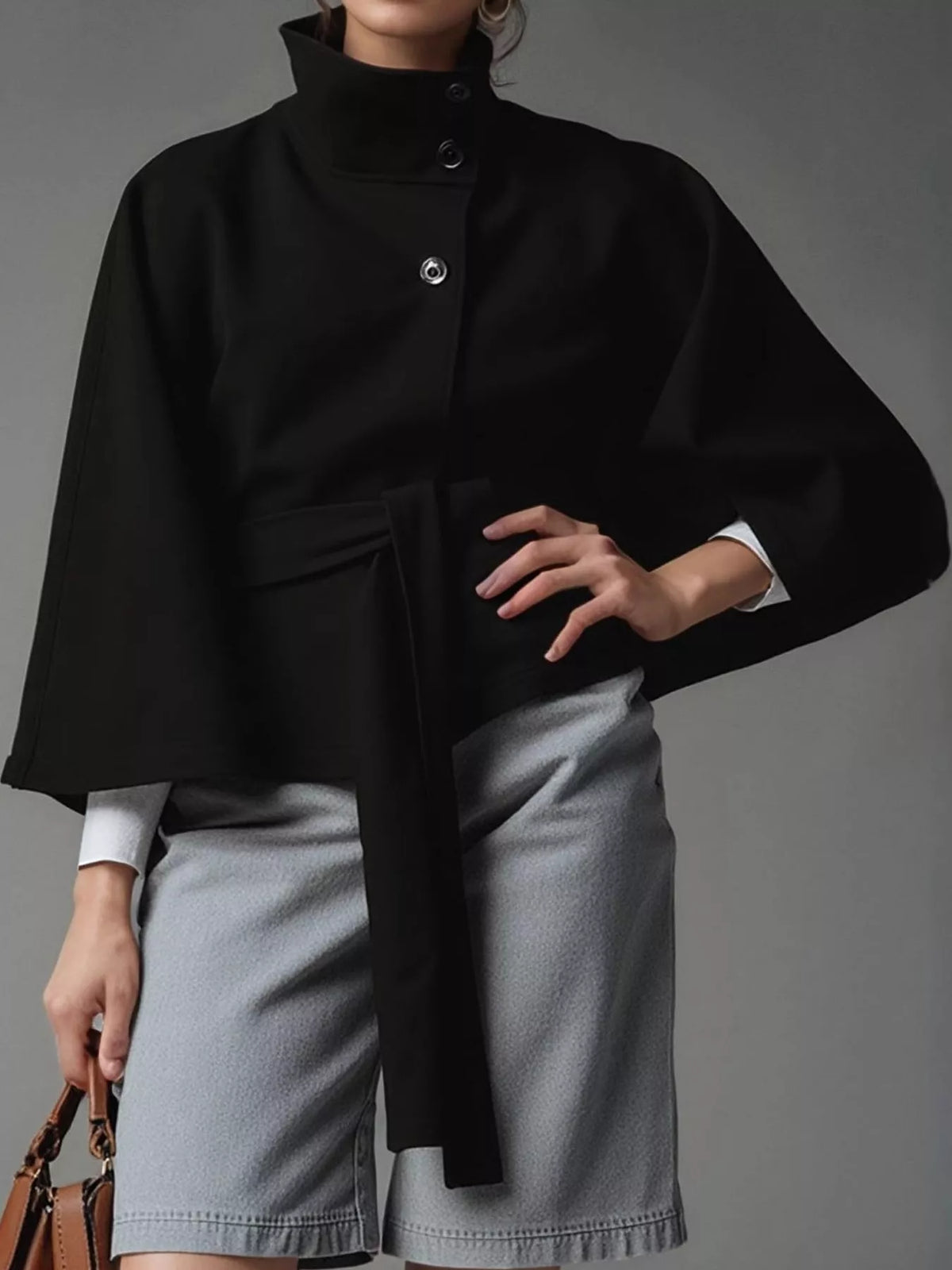 Black belted button-front cape — front view
