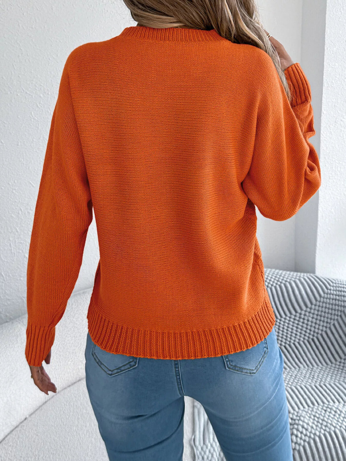 Orange cable knit crew neck sweater, back view