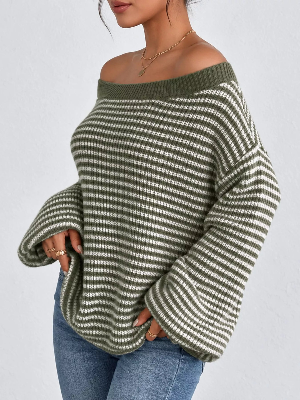 Green and white striped knit boat neck sweater, side view