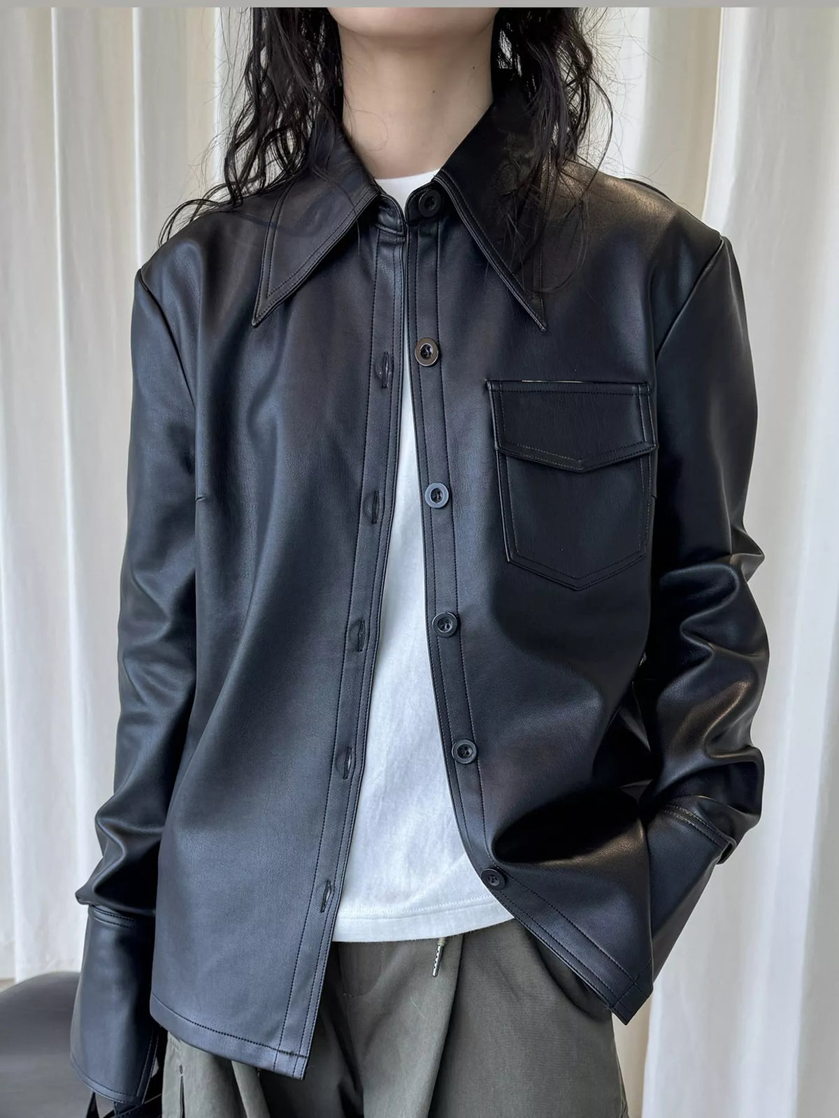 Black faux leather button-front jacket — front view