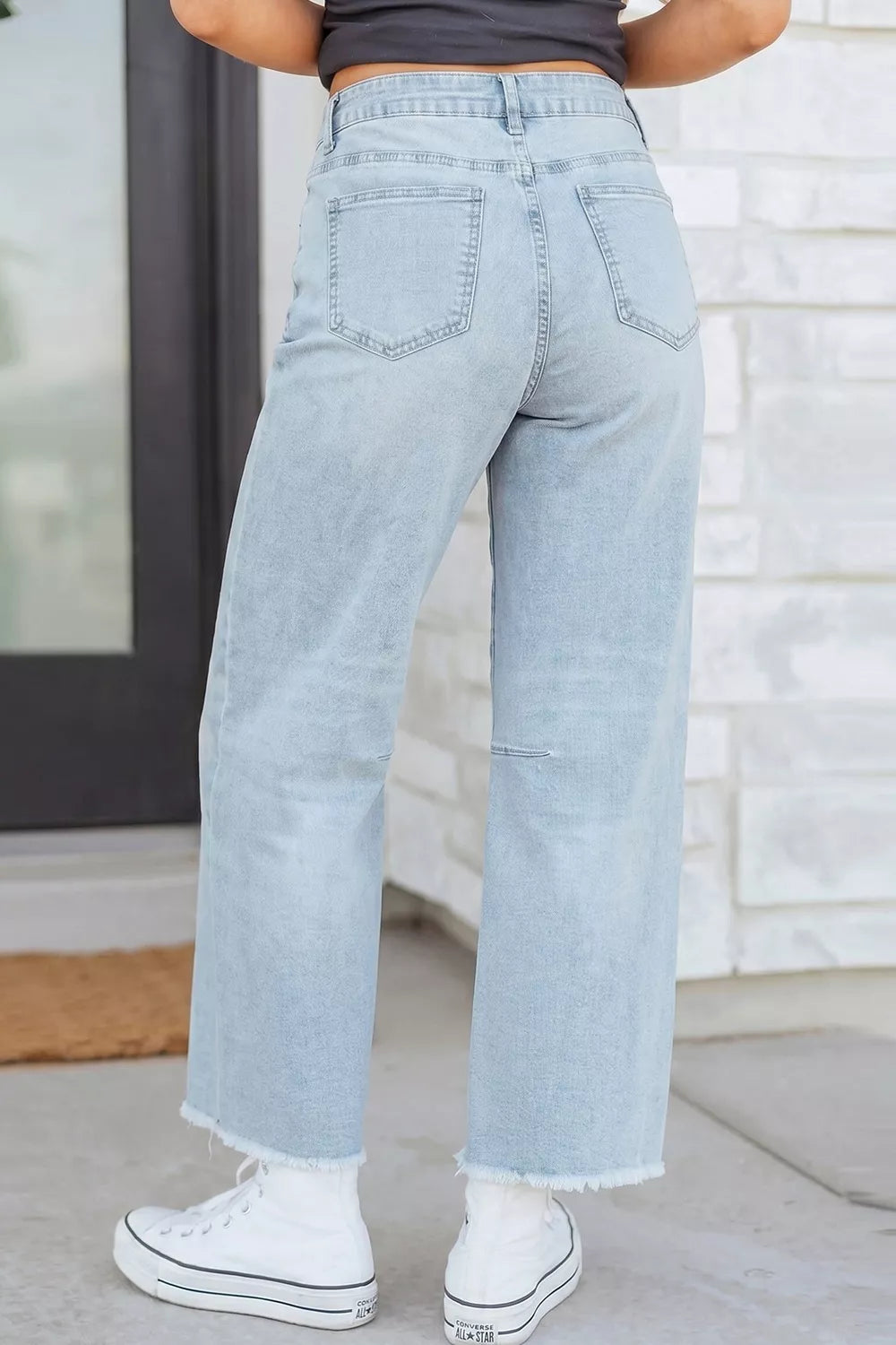 Light blue sequin turkey raw-hem ankle jeans, back view.