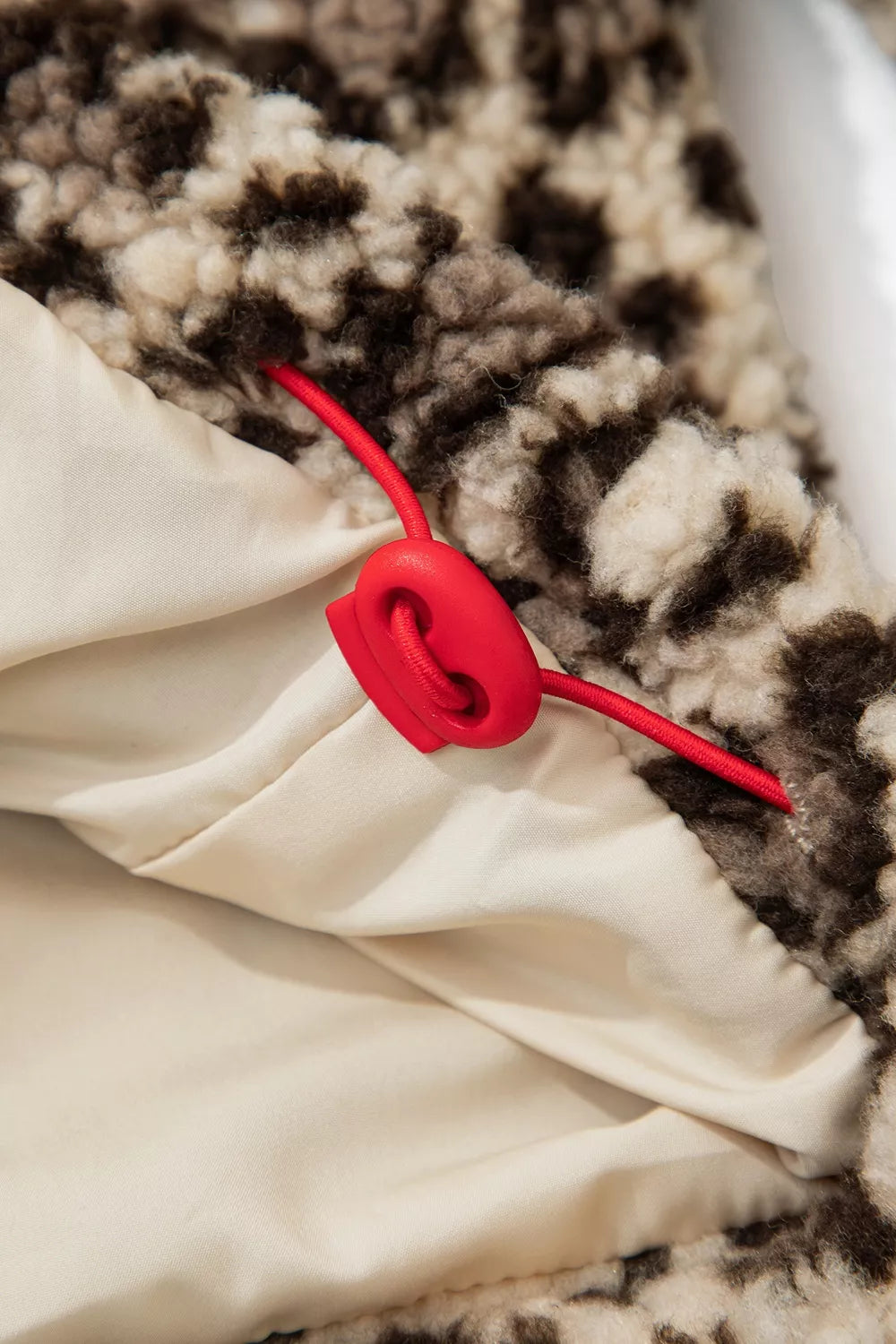 Leopard leopard half-zip sweatshirt with red trim, hem drawcord toggle detail.