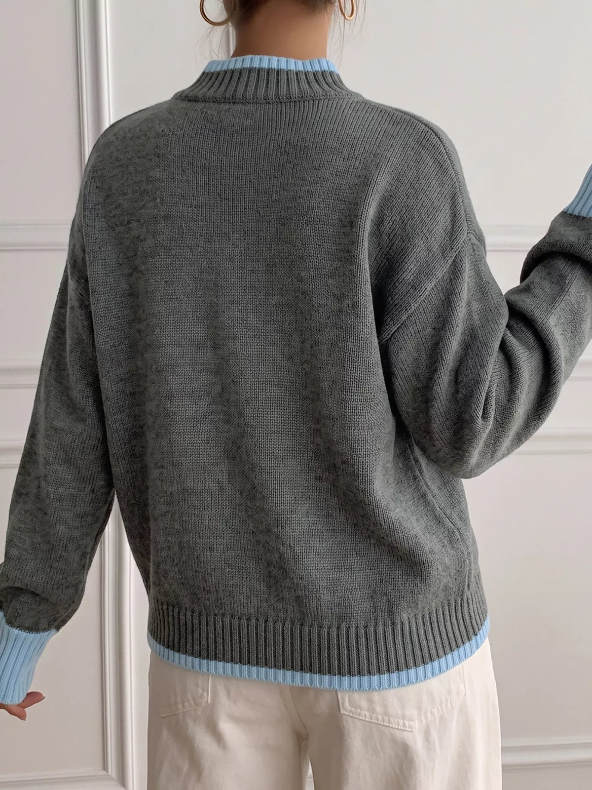 Gray sweater with blue contrast trim, back view