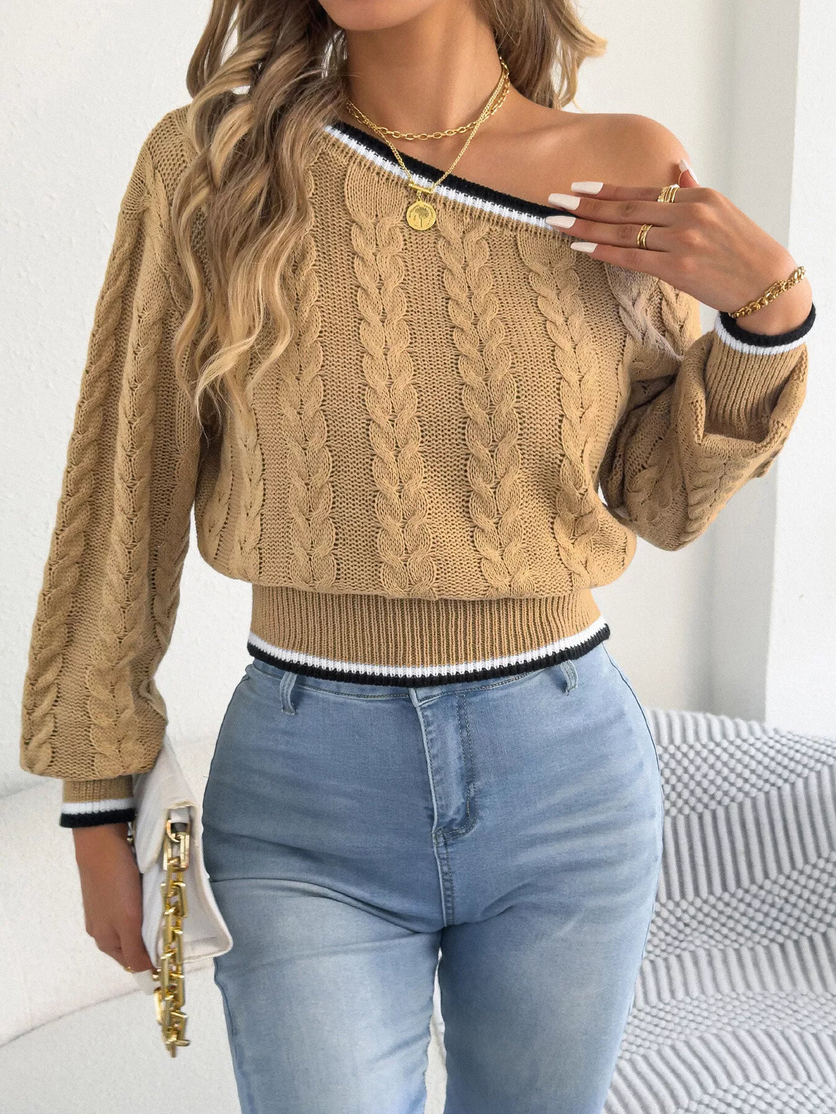 Tan one-shoulder cable knit sweater with striped trim
