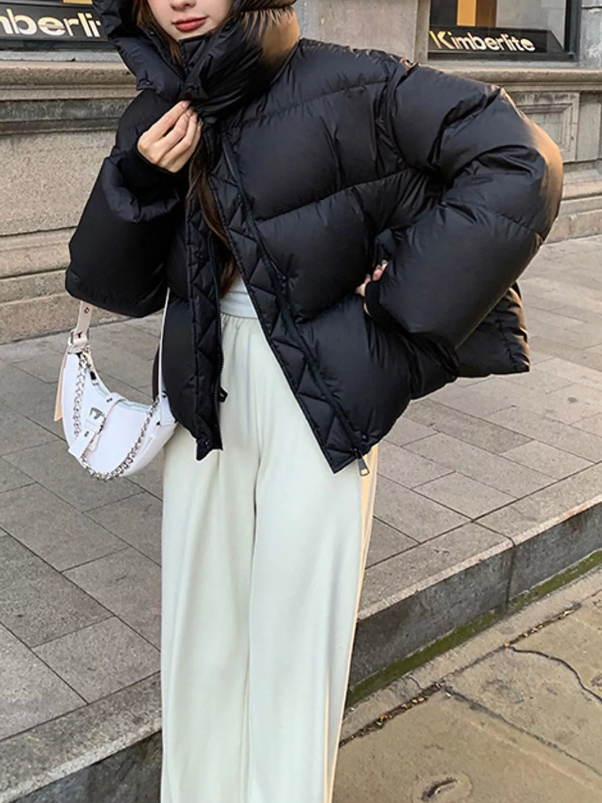 Black quilted hooded puffer jacket, collar and pocket view