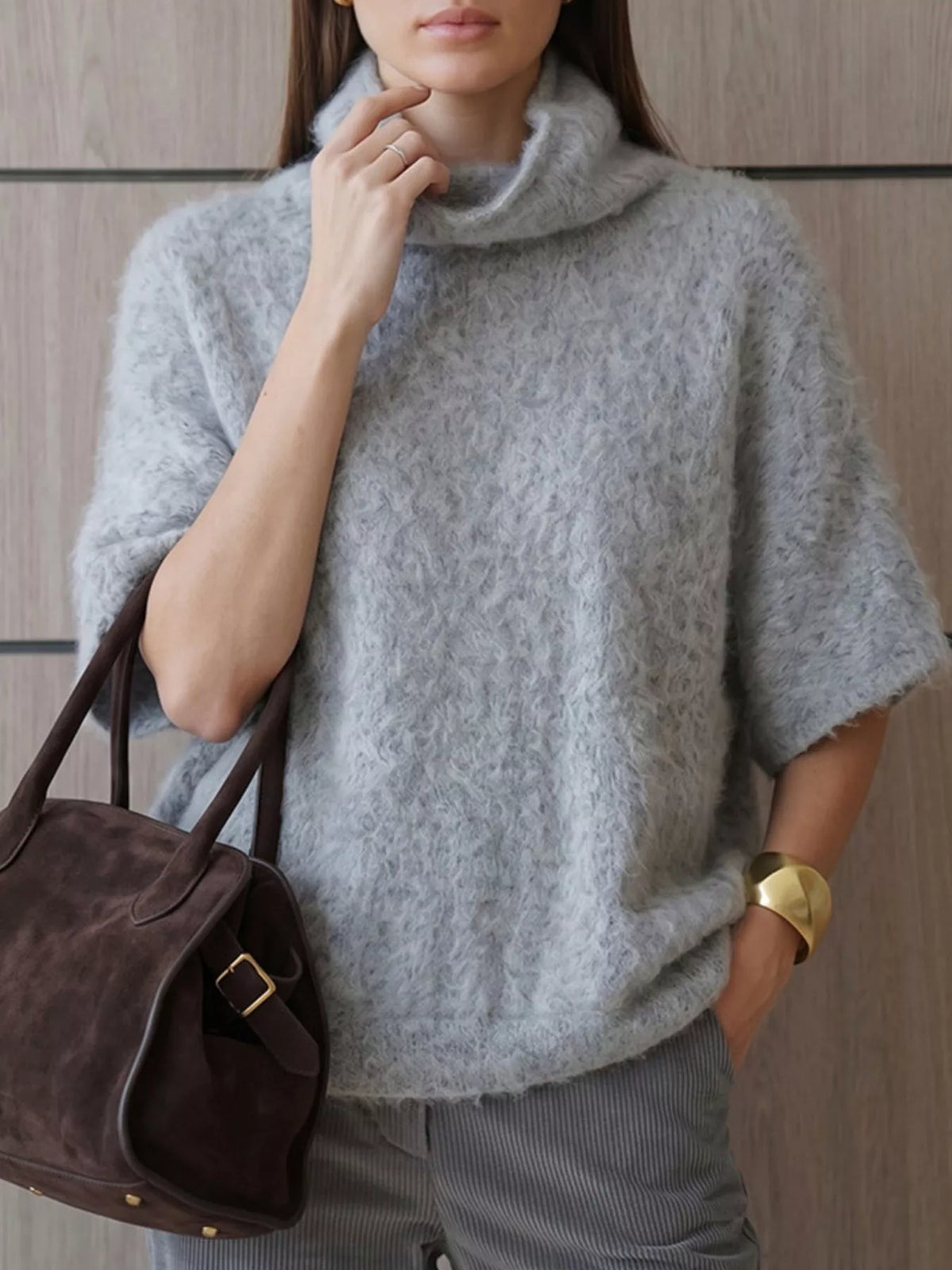Fuzzy short-sleeve turtleneck sweater in gray, angled front view with bag