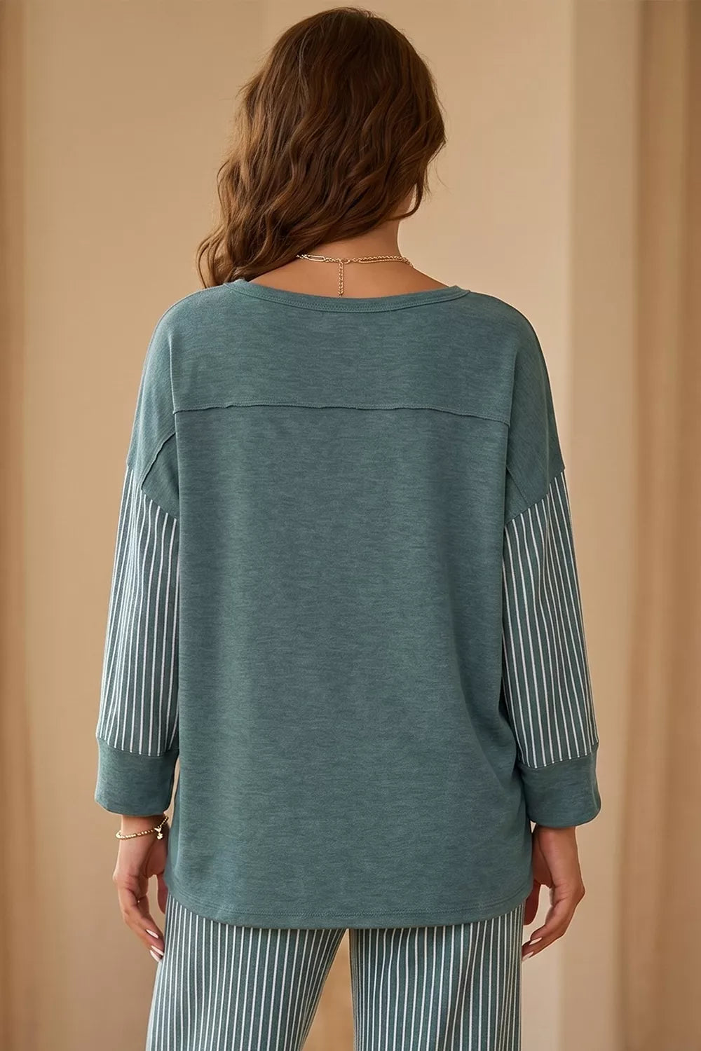 Green raw-seam top and striped pants set, back of top