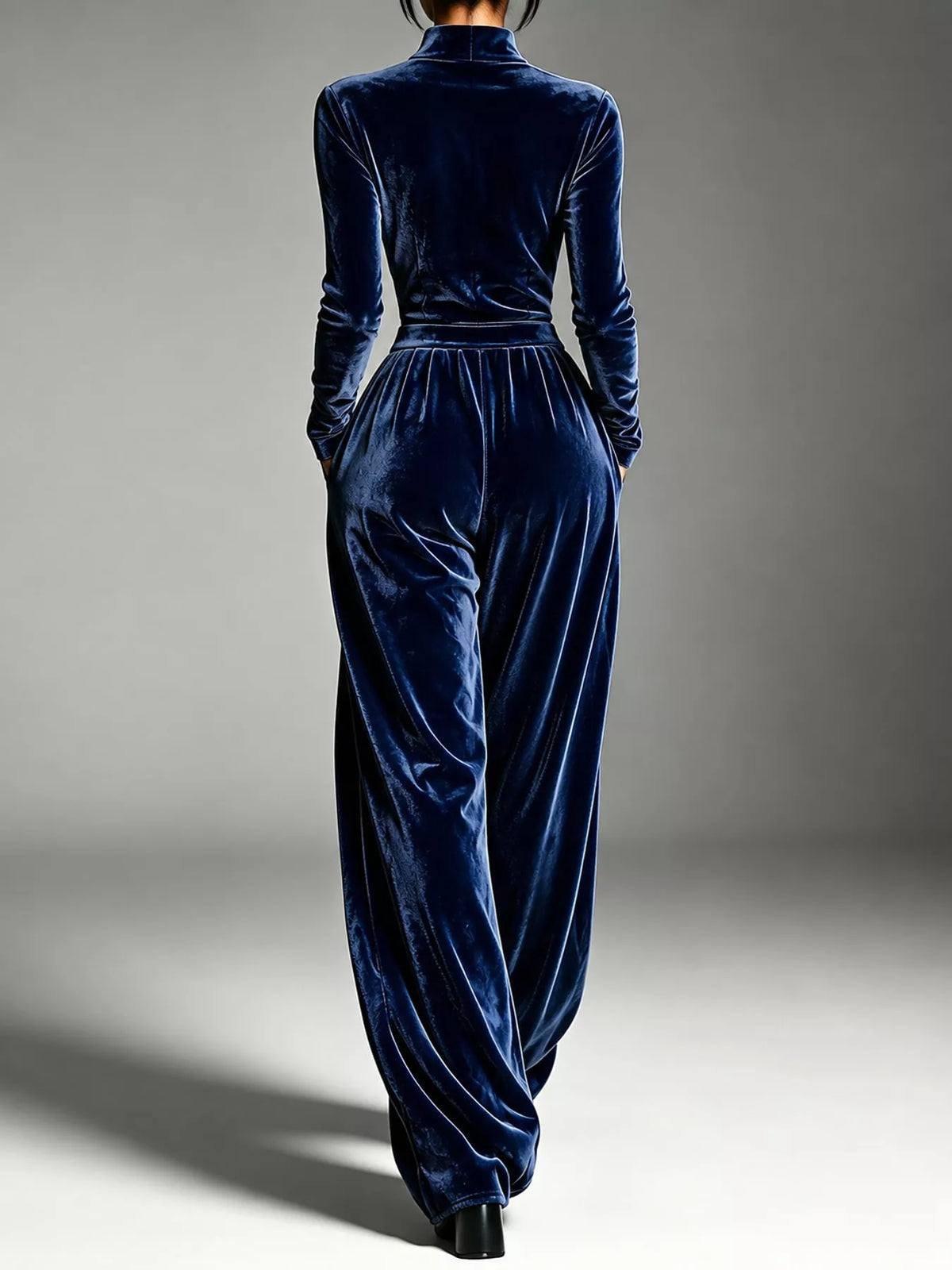 Navy blue velvet zip up jumpsuit with tie waist, back view