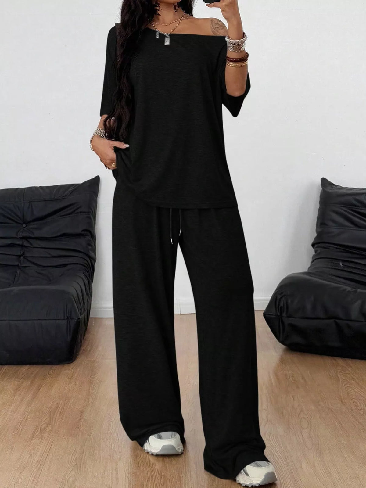 Black boat neck top and wide-leg pants set — front view