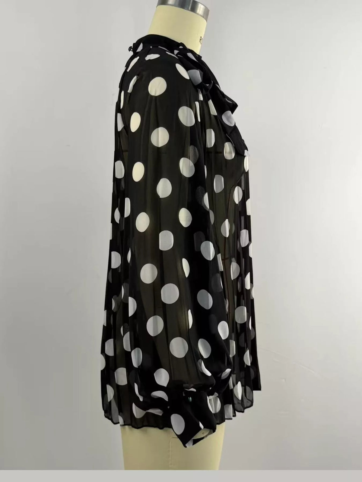 Black polka dot long sleeve blouse, detail view