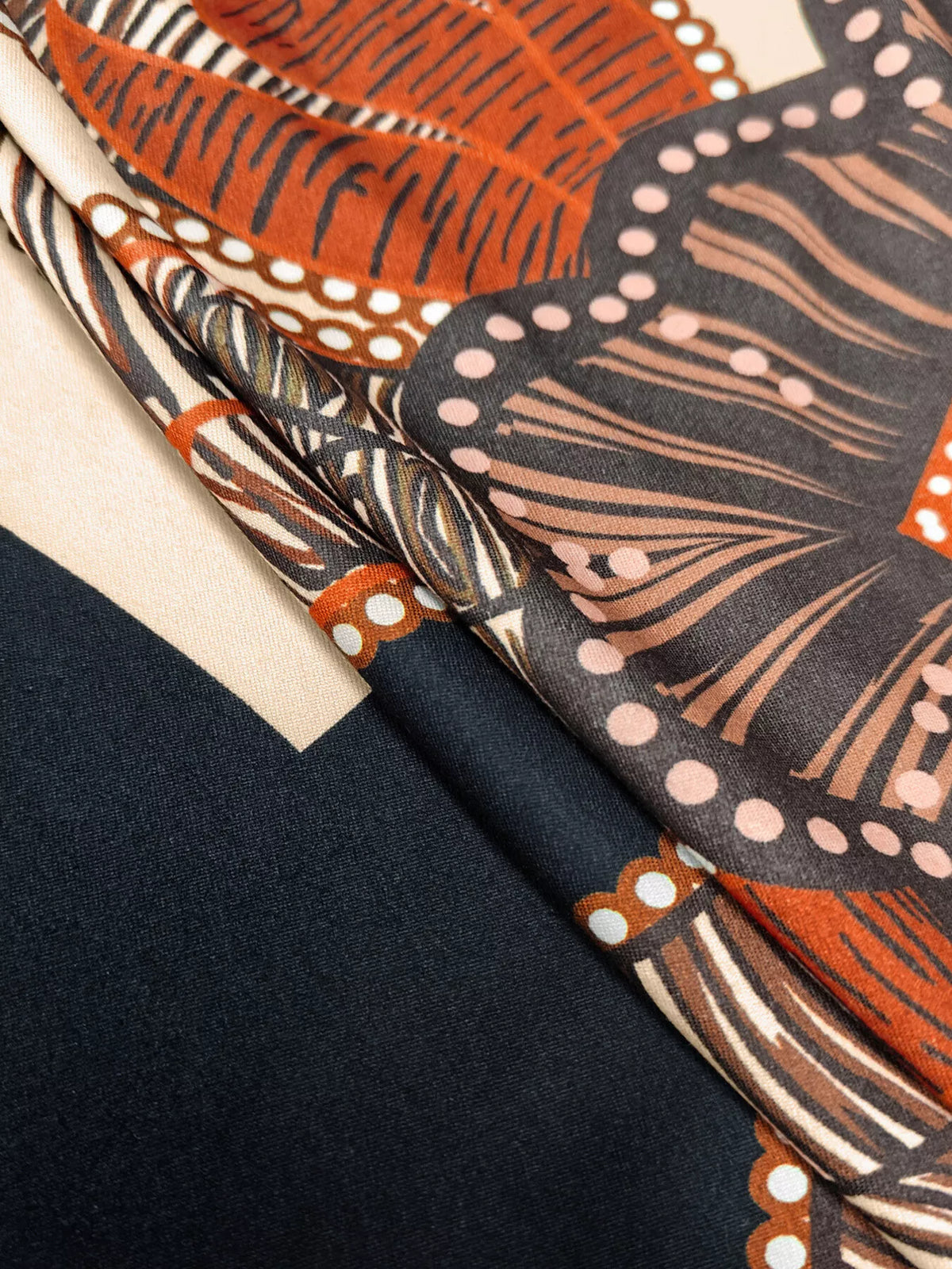 Orange, black and cream printed slit long-sleeve dress, print and fabric close-up