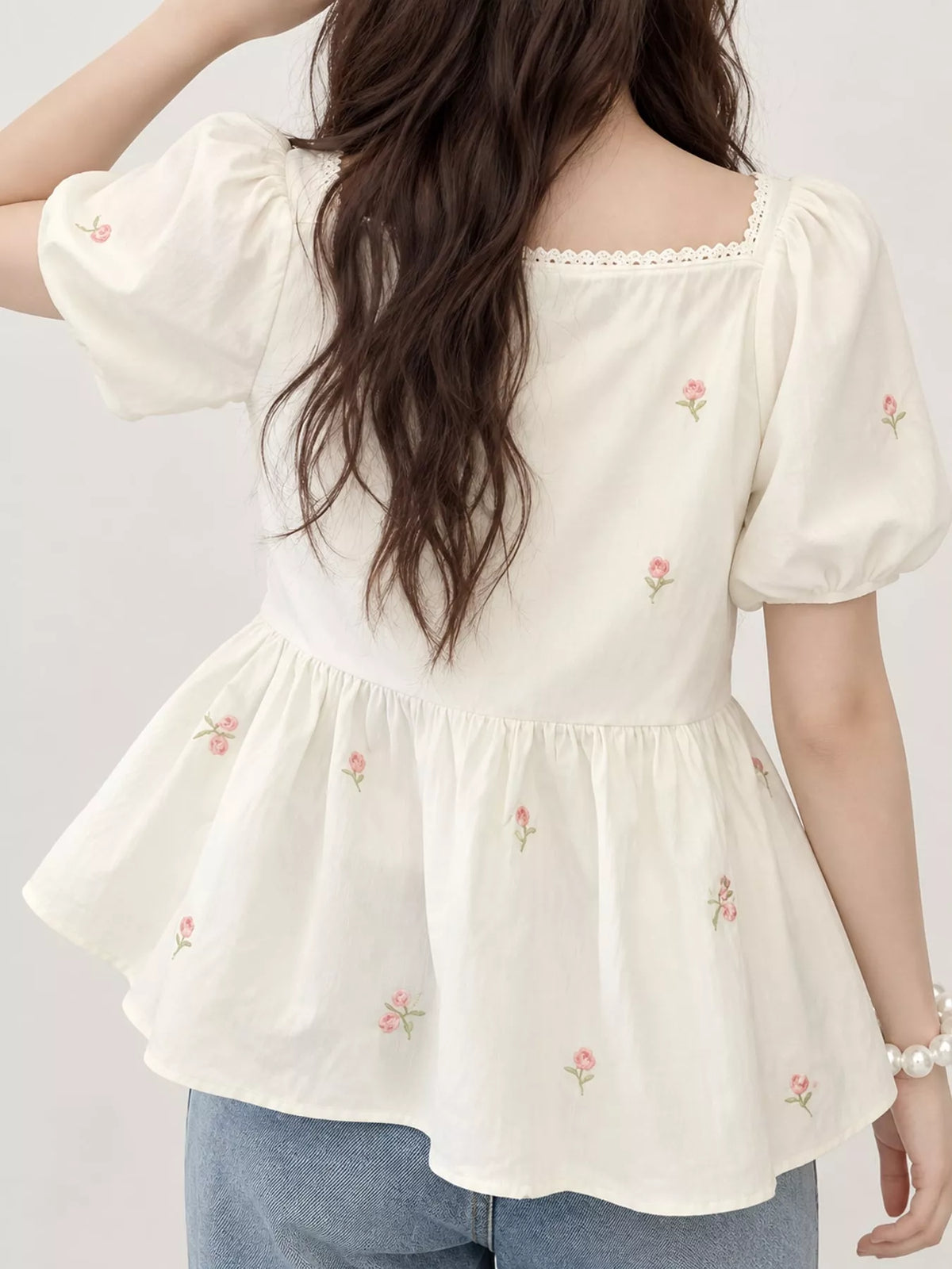 Cream floral embroidered puff sleeve peplum blouse, back view