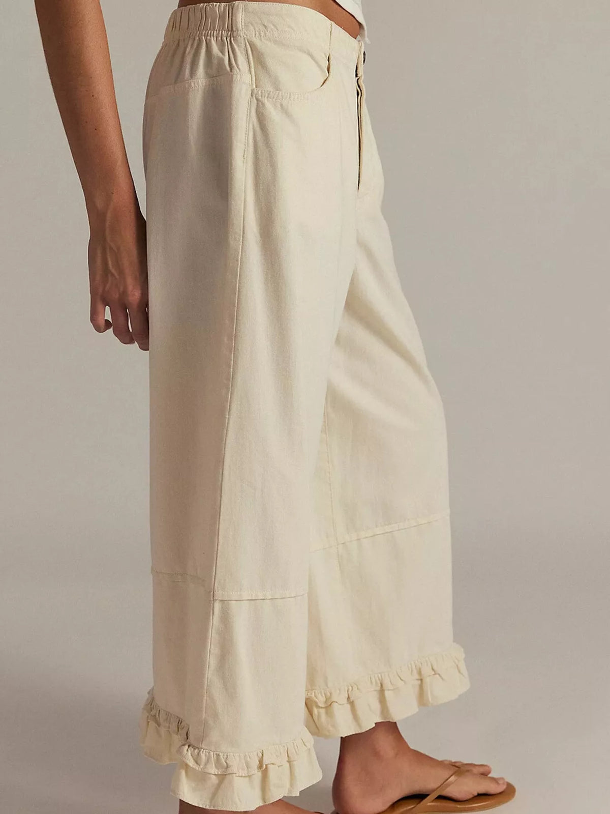Cream wide-leg ruffle-hem jeans, side view