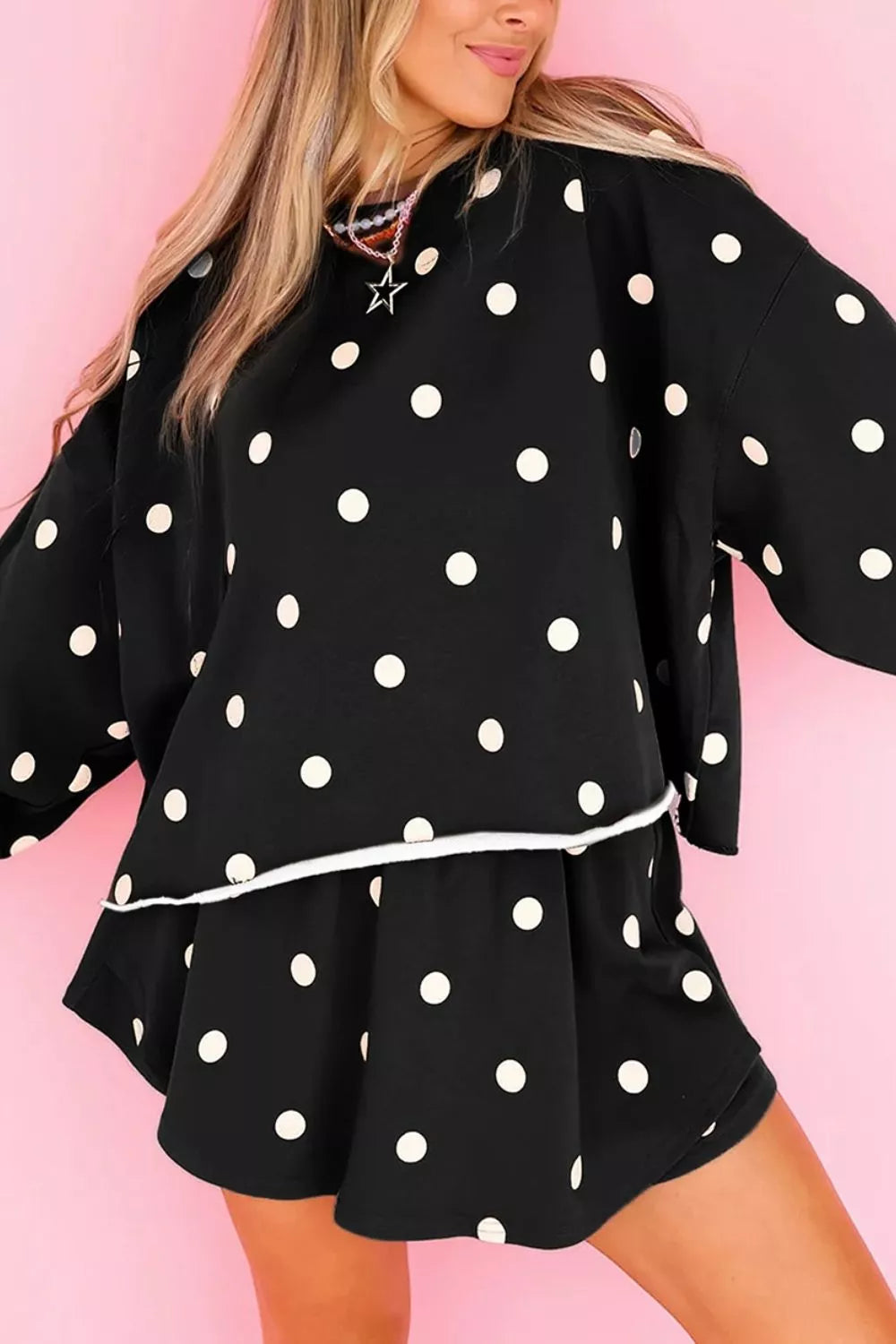 Polka Dot Raw Hem Pullover and Skort Set in black, front view