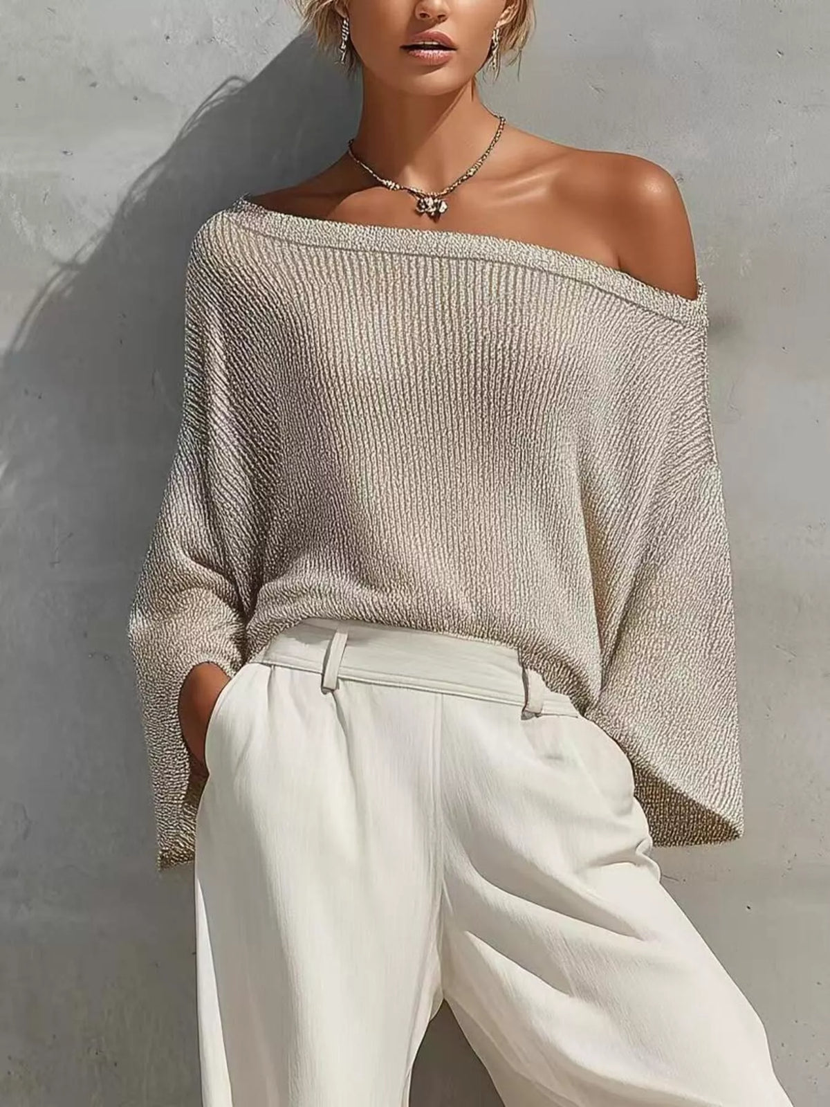 Beige one-shoulder knit top and pants set, knit top neckline detail.