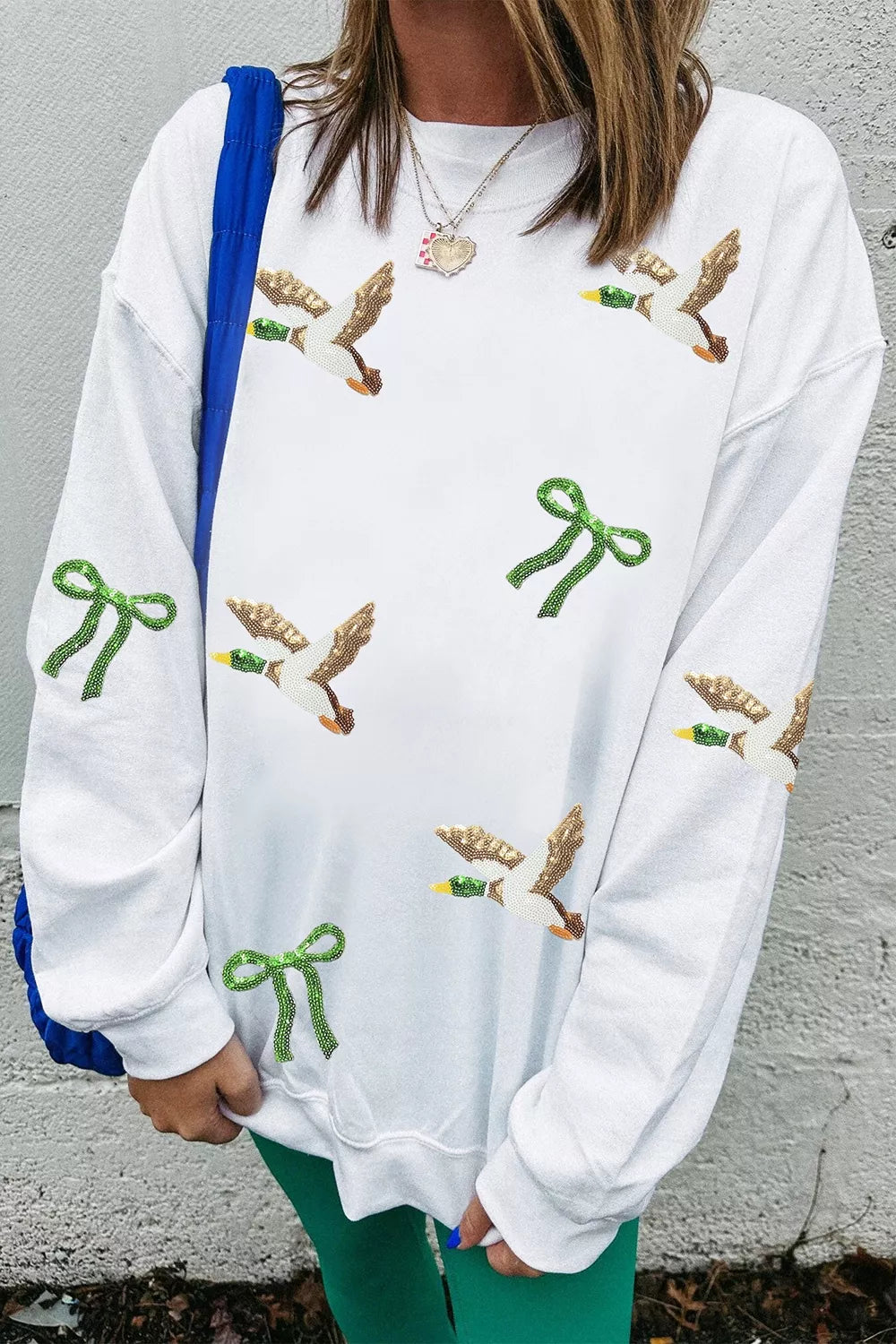 White mallard and bow sequin sweatshirt, sleeve view