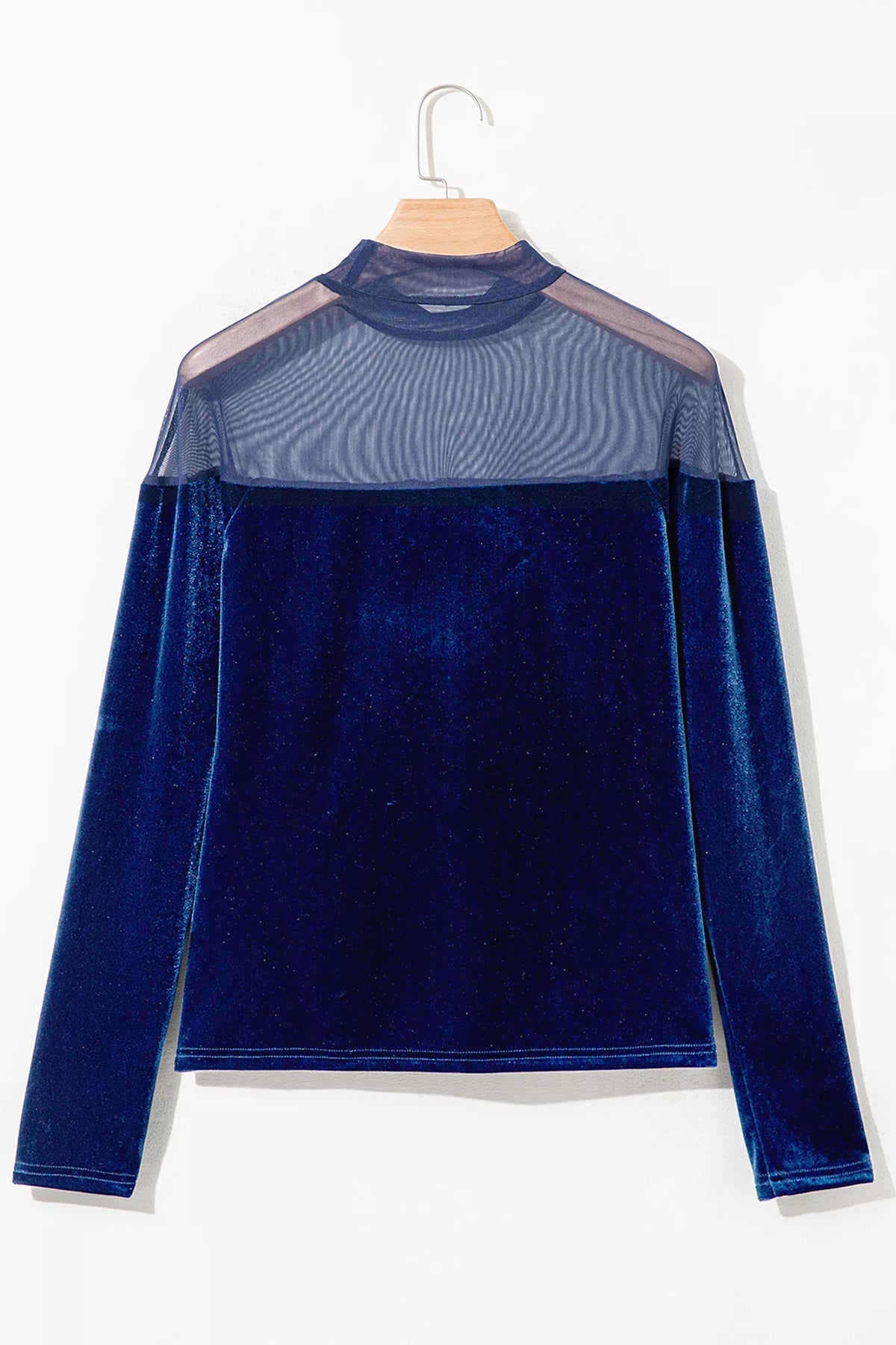 Navy velvet top with sheer yoke and long sleeves, back on hanger.