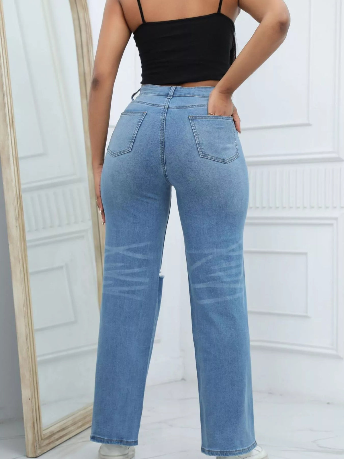 Medium blue distressed wide-leg jeans, back side view