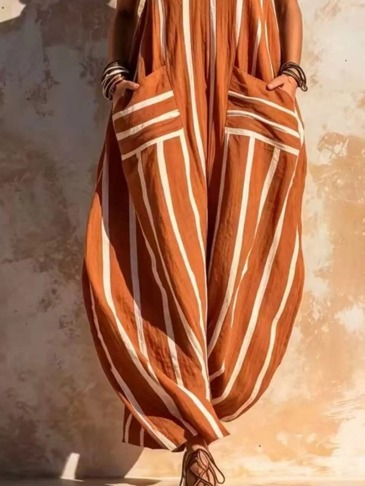 Orange and white striped sleeveless jumpsuit, pocket and leg detail